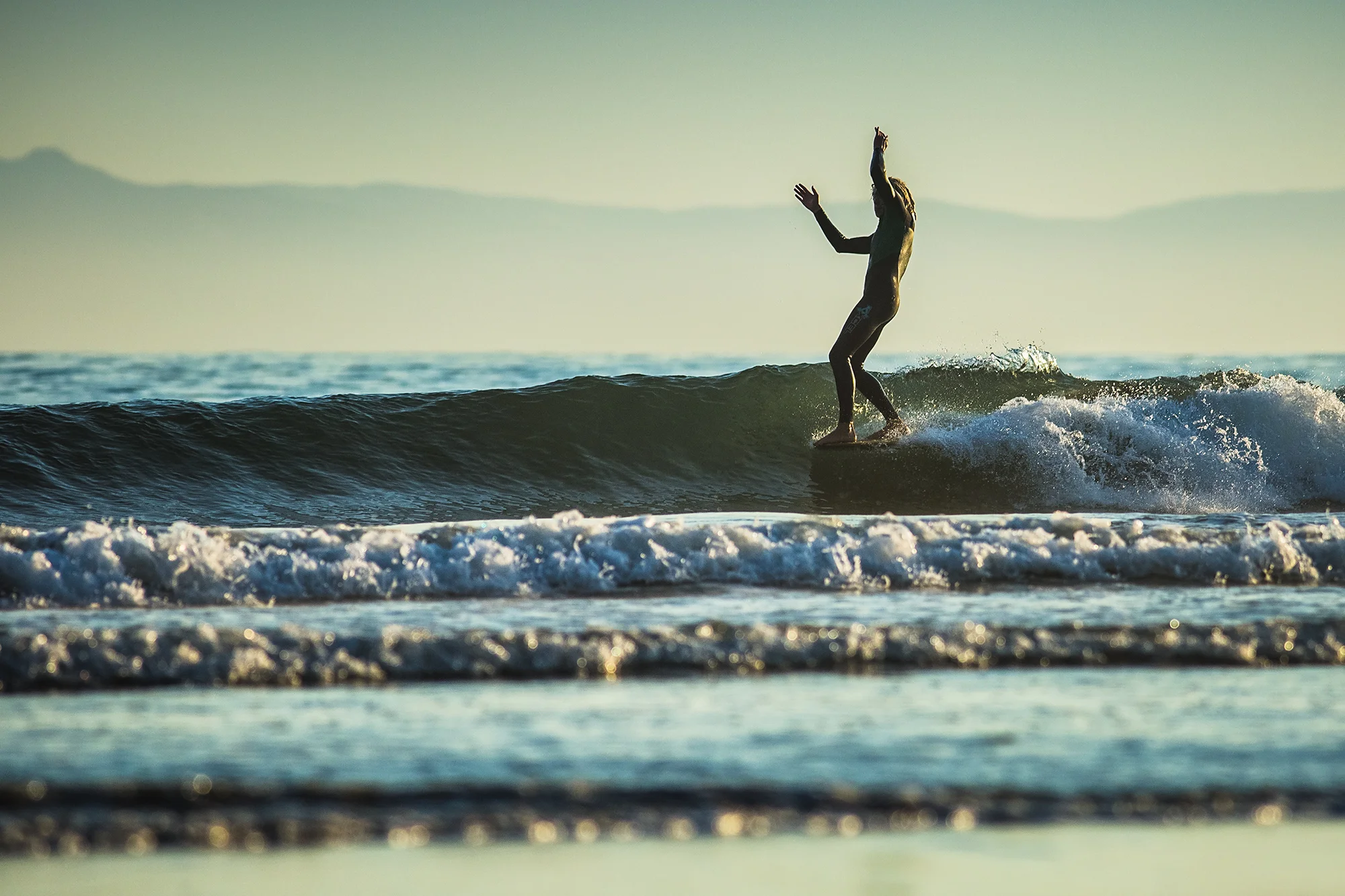  Handheld, Longboarder gets five toes on the nose at Rincon Point, California 