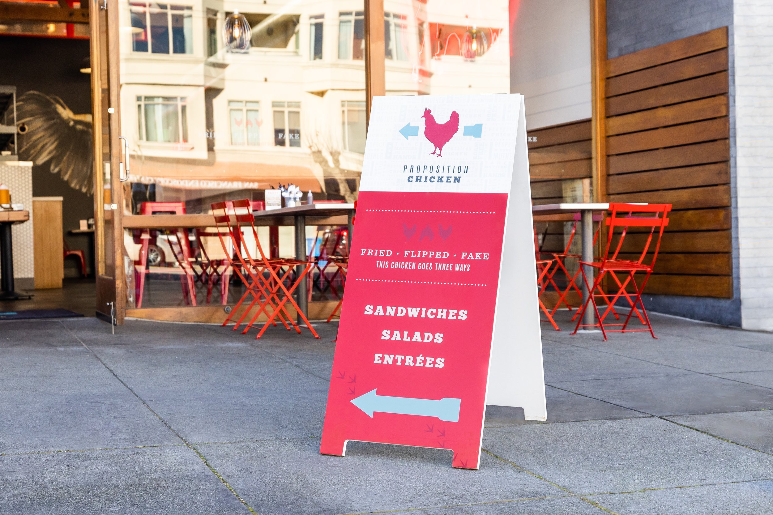 proposition chicken sandwich board in front of a store.jpeg