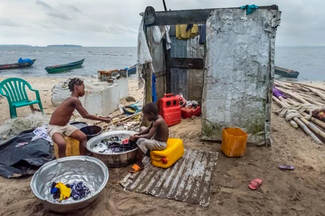 A couple of children do the laundry of the whole family.