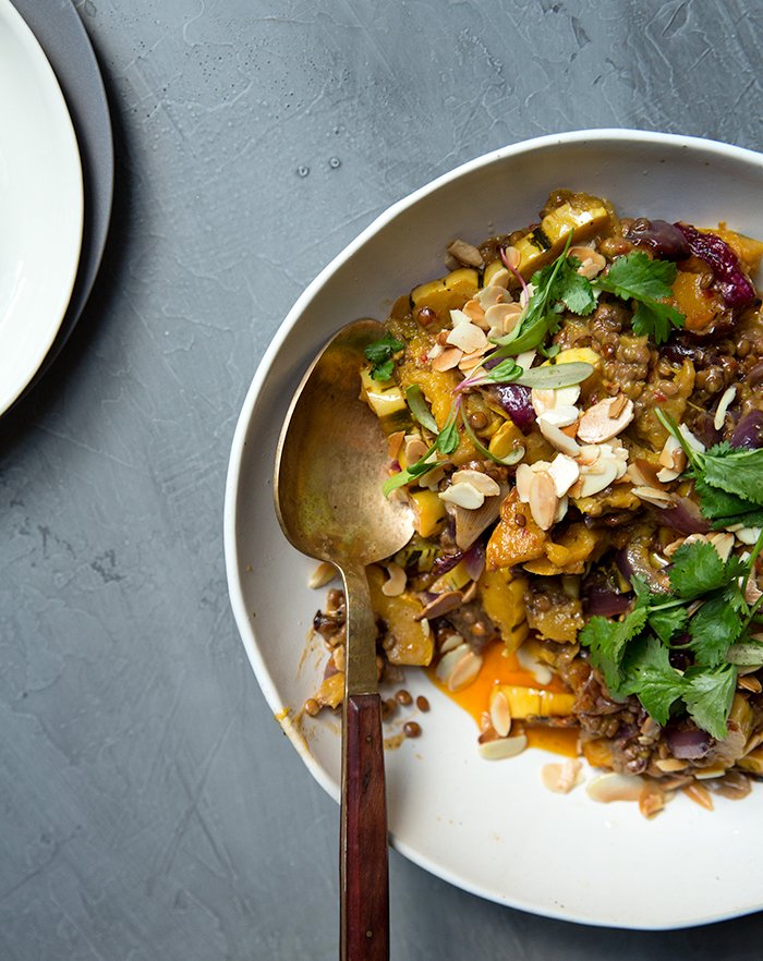 harissa + coconut milk baked delicata squash with lentils + toasted almonds