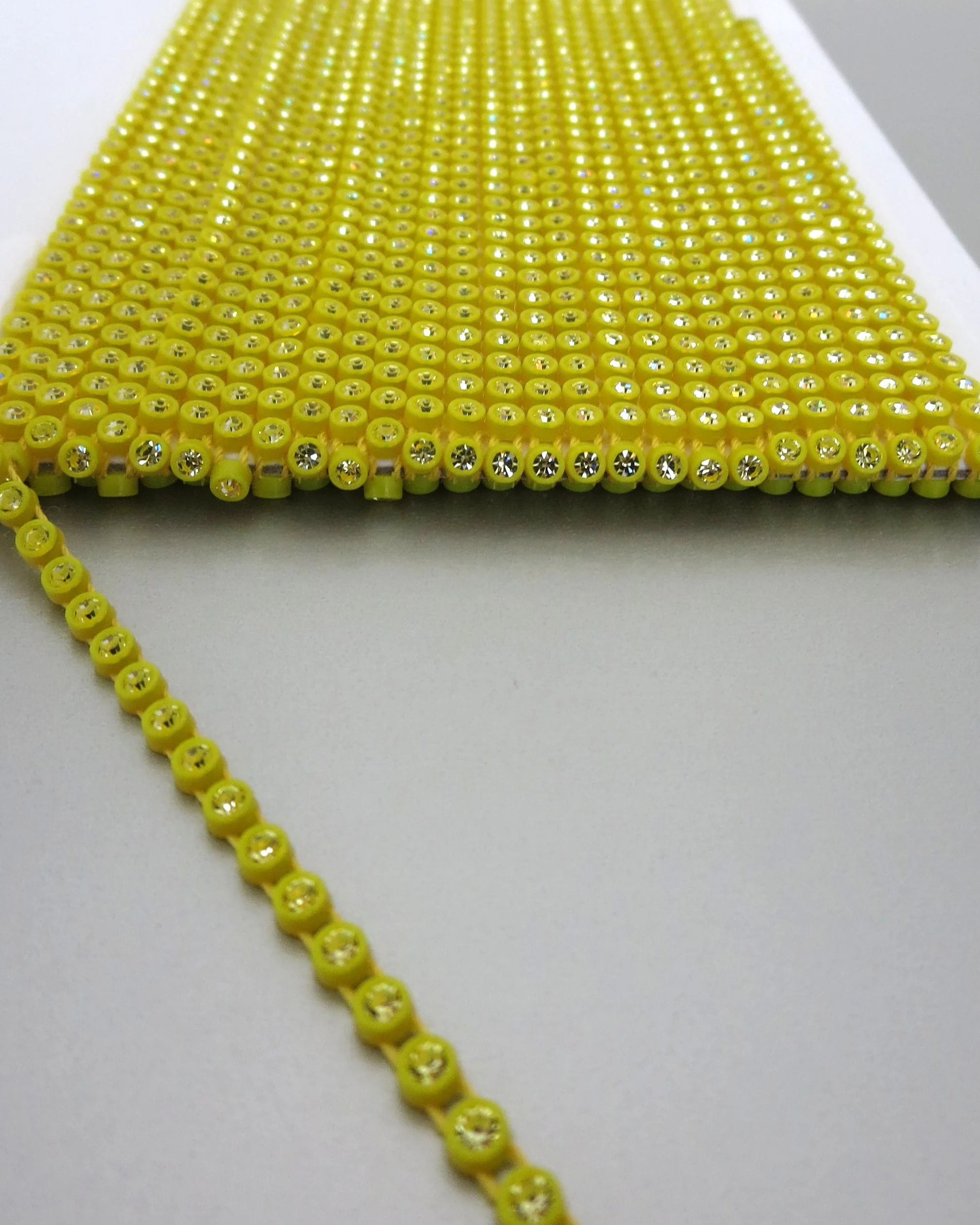 The Buffalo Bead Gallery. Plastic Cup Chain of Preciosa Crystal connected by parallel threads, flexible, open spaces allow for needle pass through.