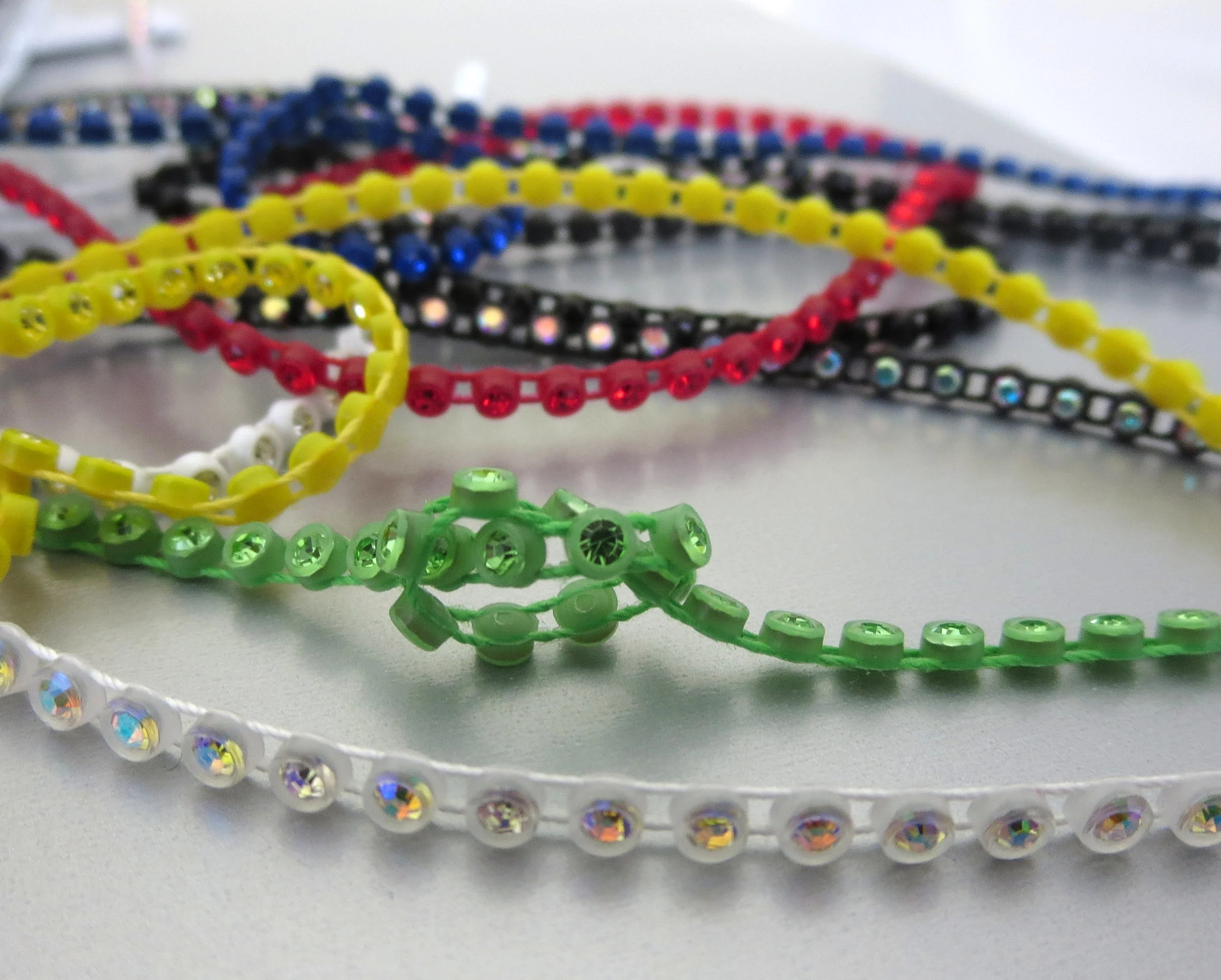 The Buffalo Bead Gallery. Plastic Cup Chain of Preciosa Crystal connected by parallel threads, flexible, open spaces allow for needle pass through.