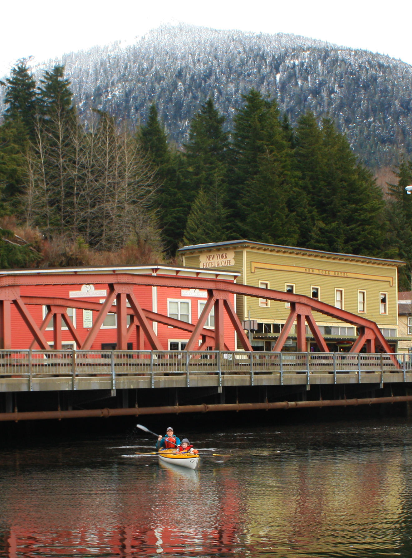  Snow on the mountains and high tide at the Creek Street Bridge in Ketchikan, Alaska 