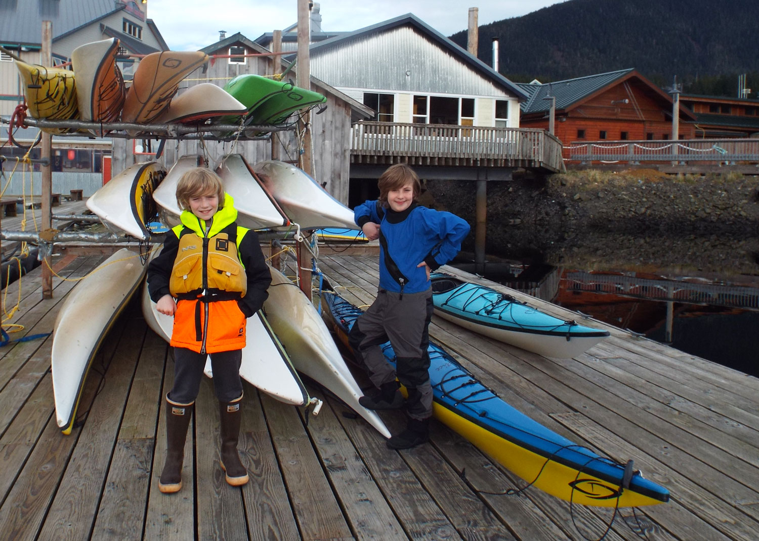  Dressed to kayak: PFD and high visibility rain gear and kid size dry suit for winter paddling. 