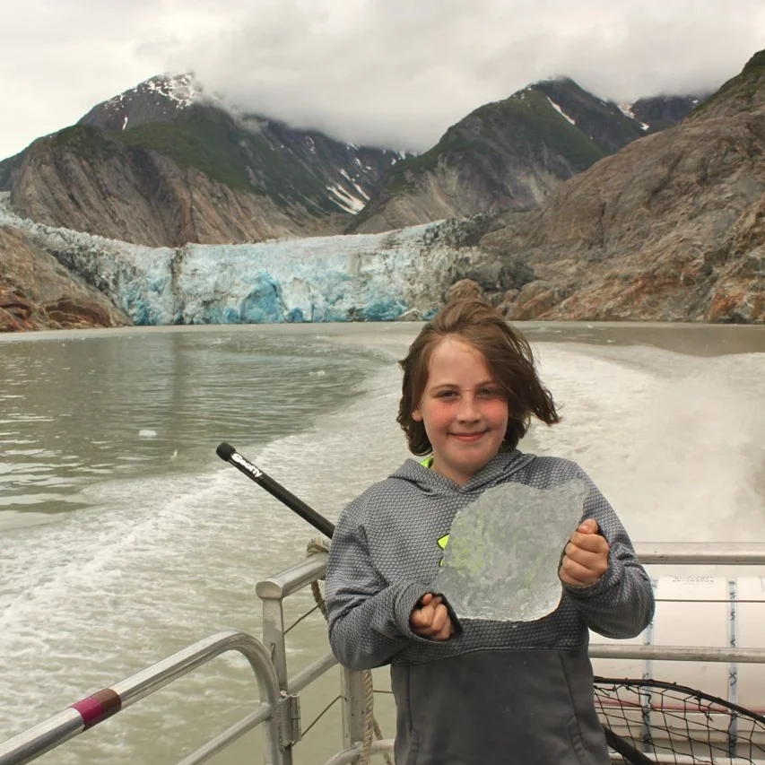 Declan holds a chunk of glacier on the Tracy Arm Boat Tour.