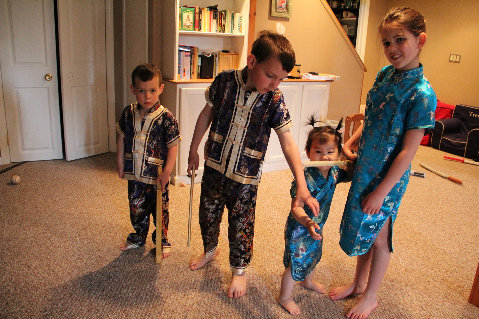 All dressed in their outfits from China and she's already a warrior with her brothers sword.