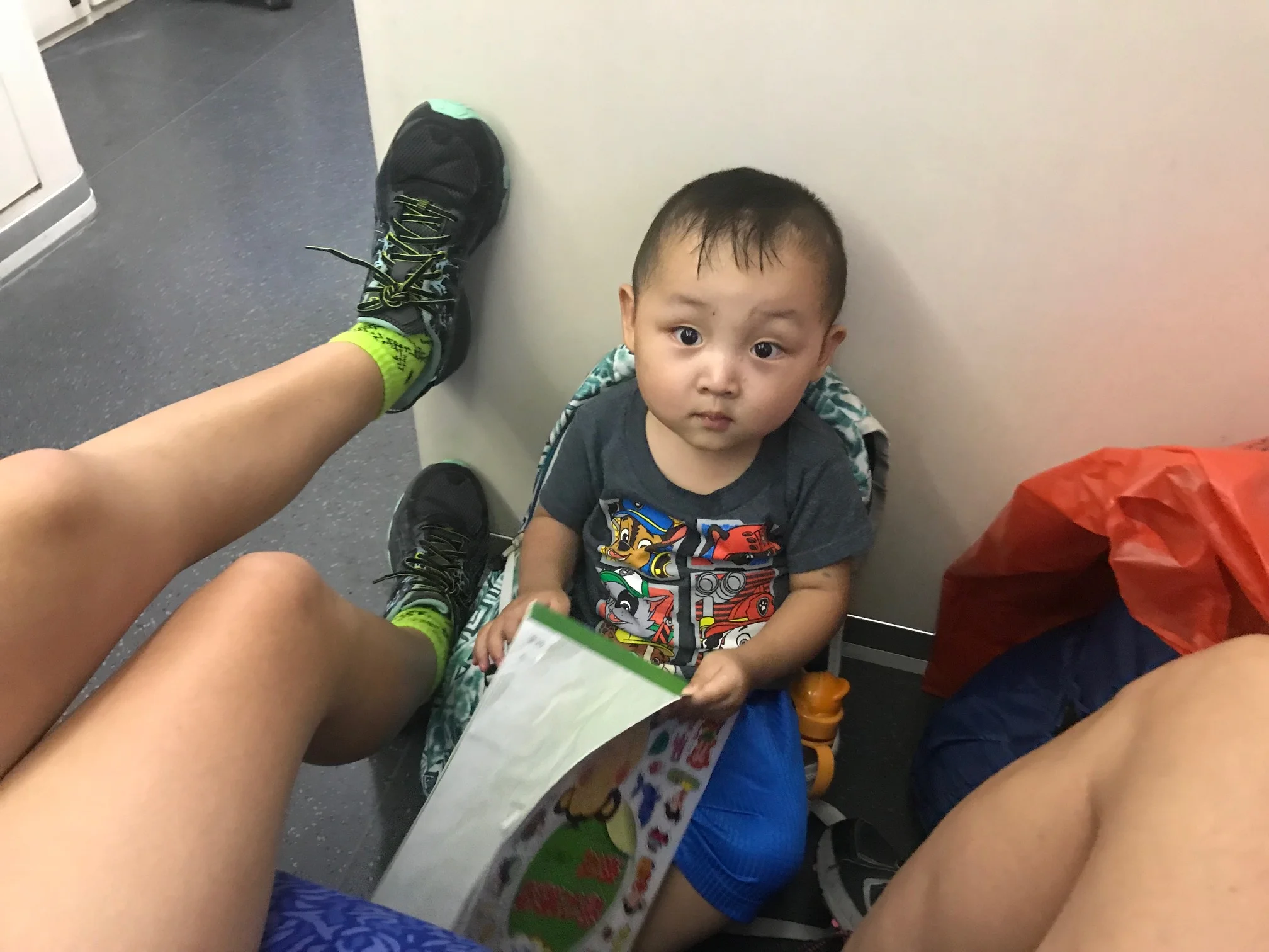Luke made himself a seat out of Abigail's backpack on the floor of the train to Hong Kong.