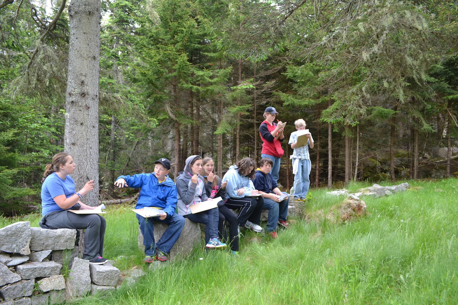VH students sit in at the foundation of the old catholic church and make observations and educated guesses about what else might have been in this area during the quarry era