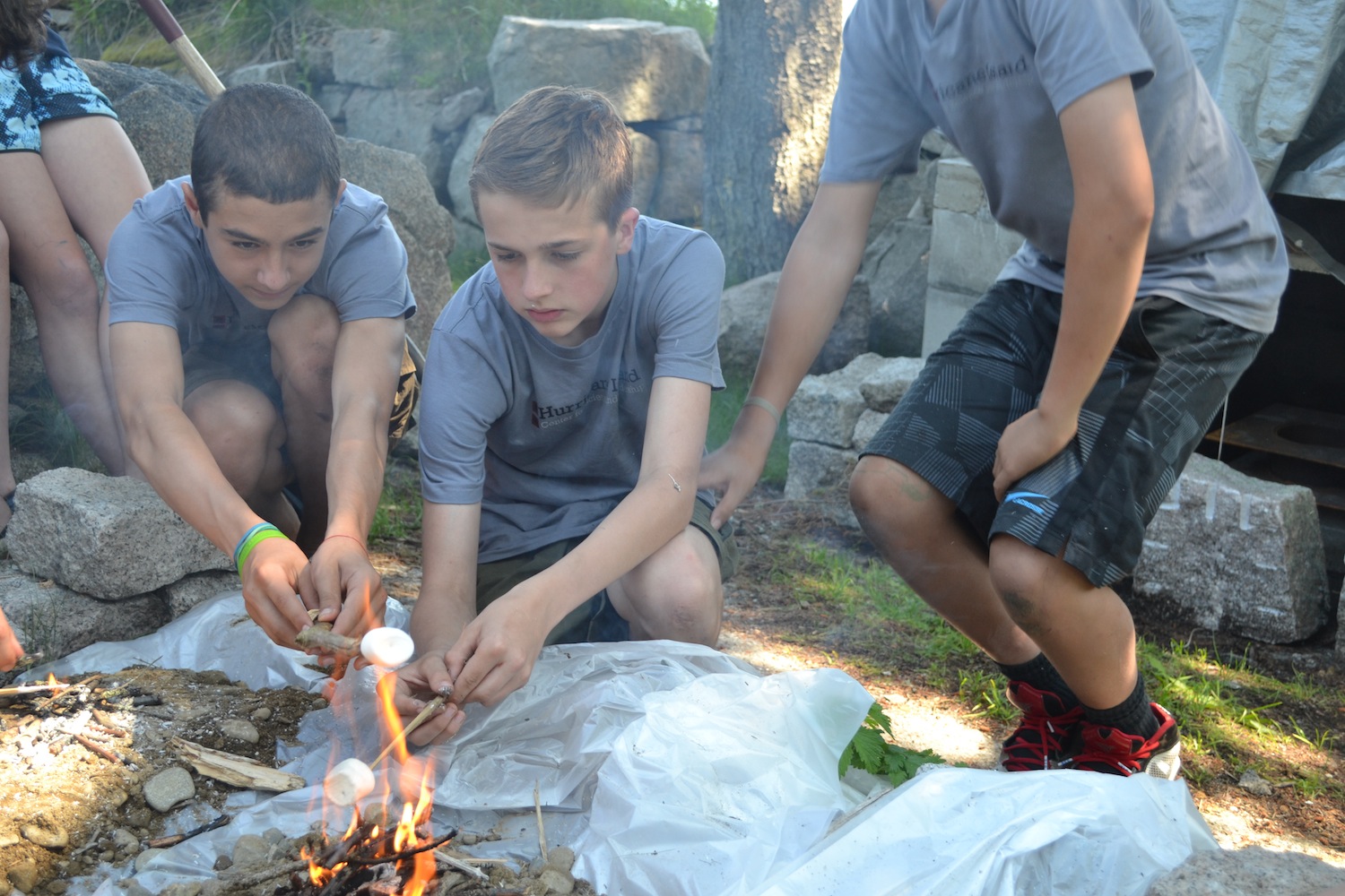 Students enjoy some marshmallows cooked on using the mound fire technique.