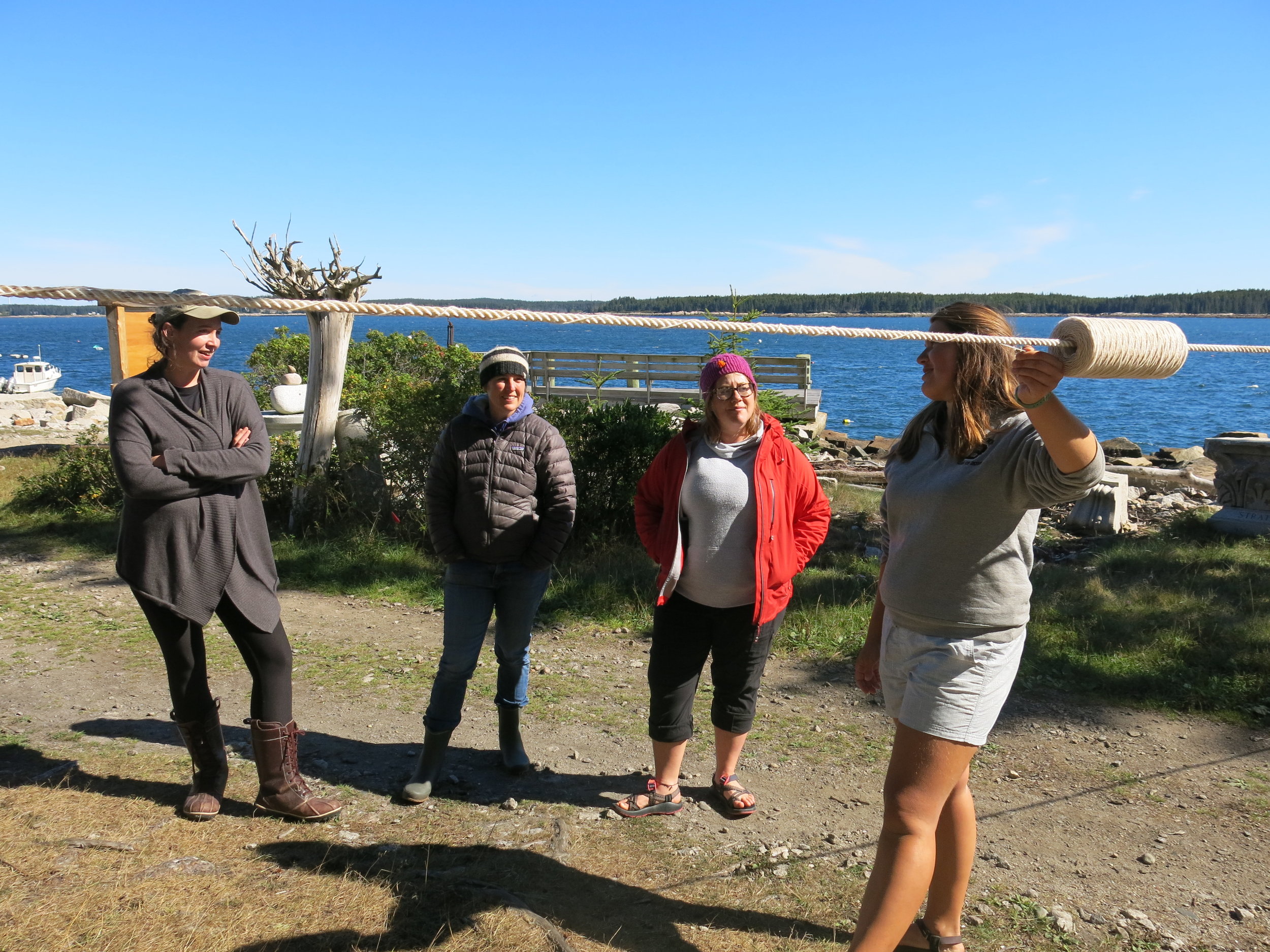 Bailey demonstrating how to string seeded kelp line to the long line