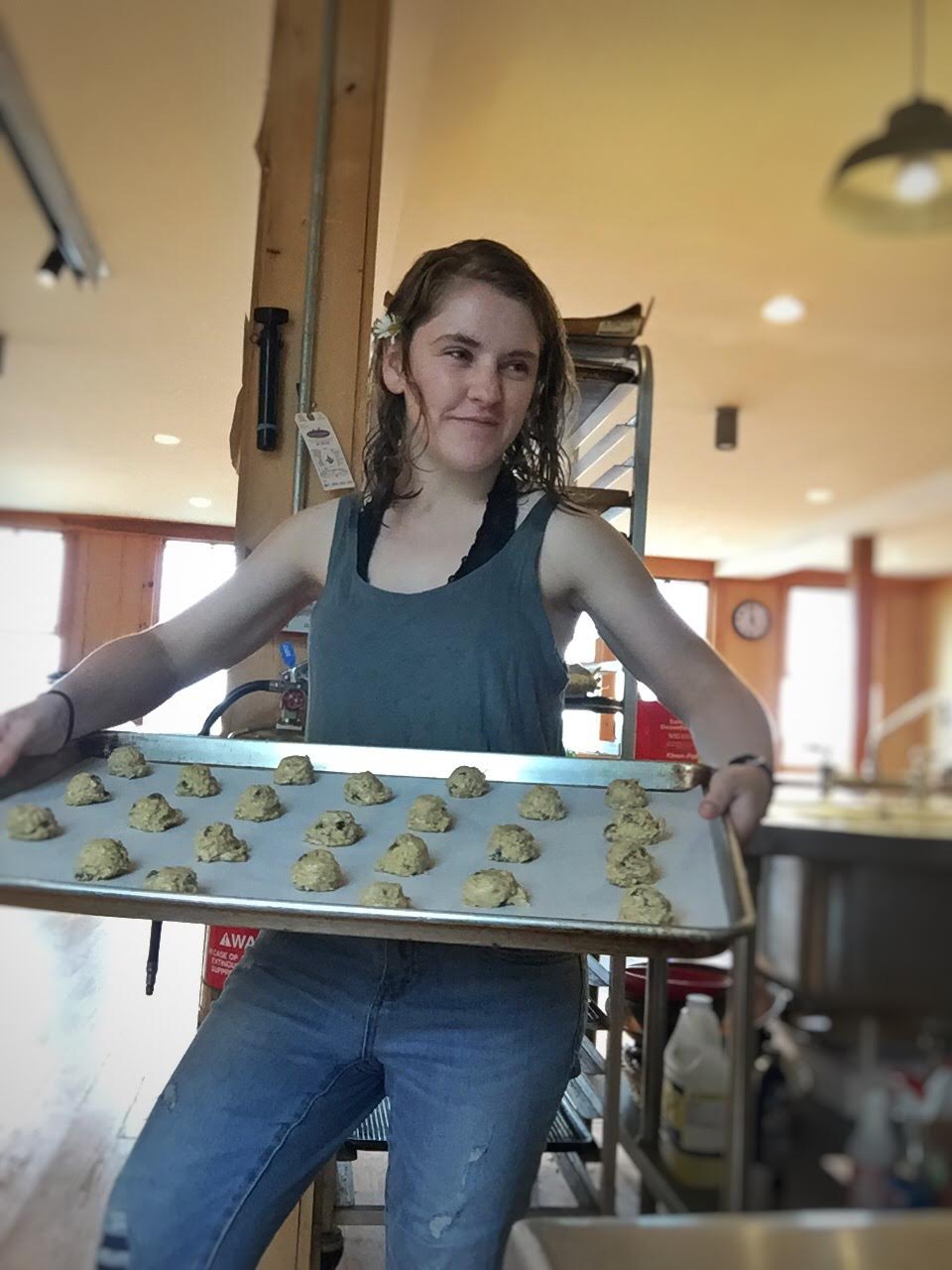 Phoebe in the galley with a big tray of oatmeal chocolate chip cookies