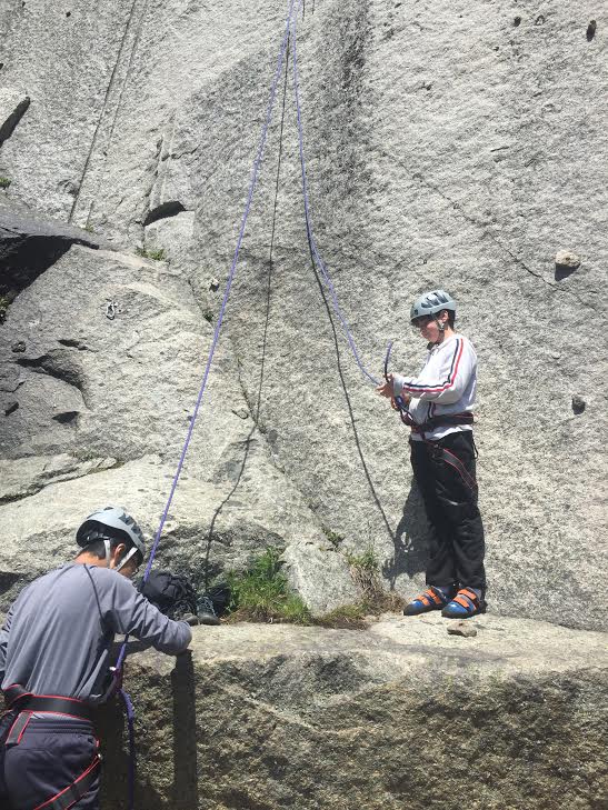 Sam learns the ropes on our climbing wall.