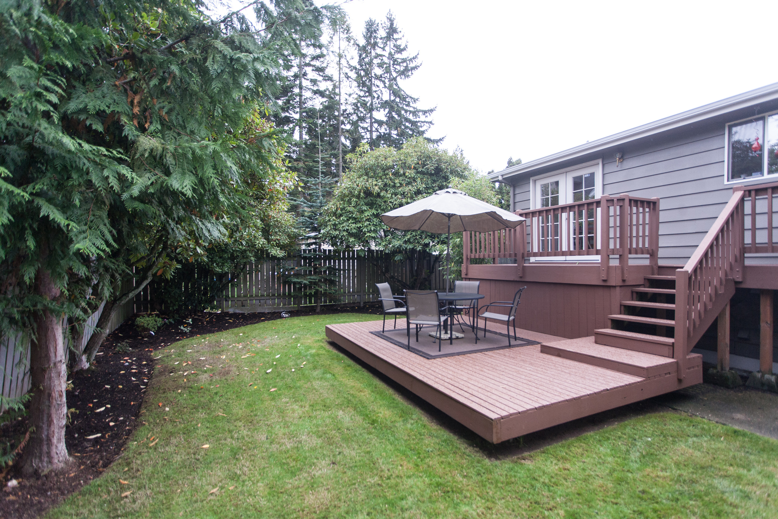   ...a lovely tiered deck for BBQ's and summer-living that overlooks a fully-fenced back yard.  