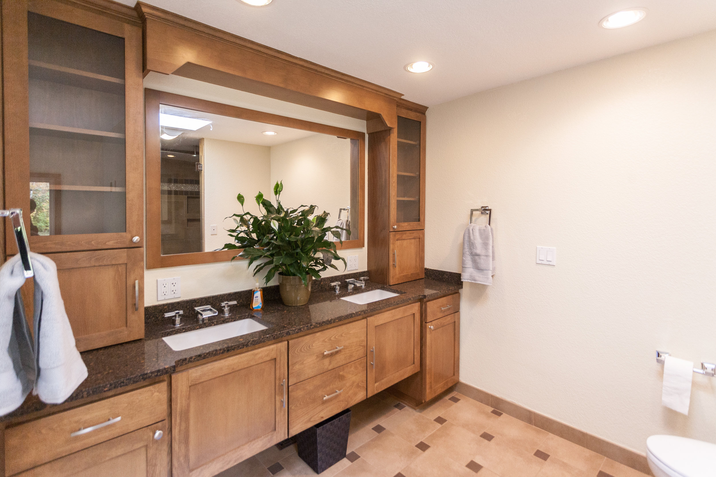  Dual-vanity in the master-bath. Notice the faucet fixtures and ample linen storage. 