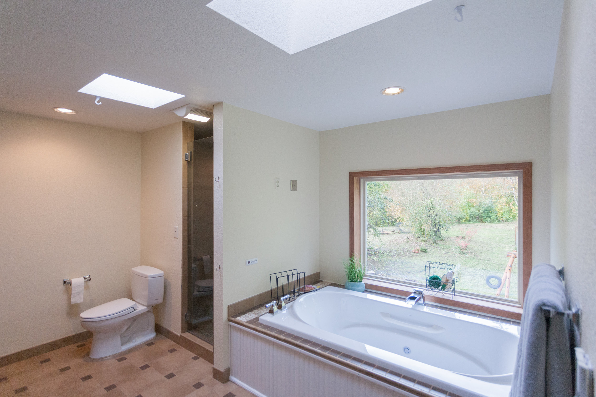  Master-bath with heated floors, wired for electronics, jetted Bain tub, skylights, and waterfall shower. 