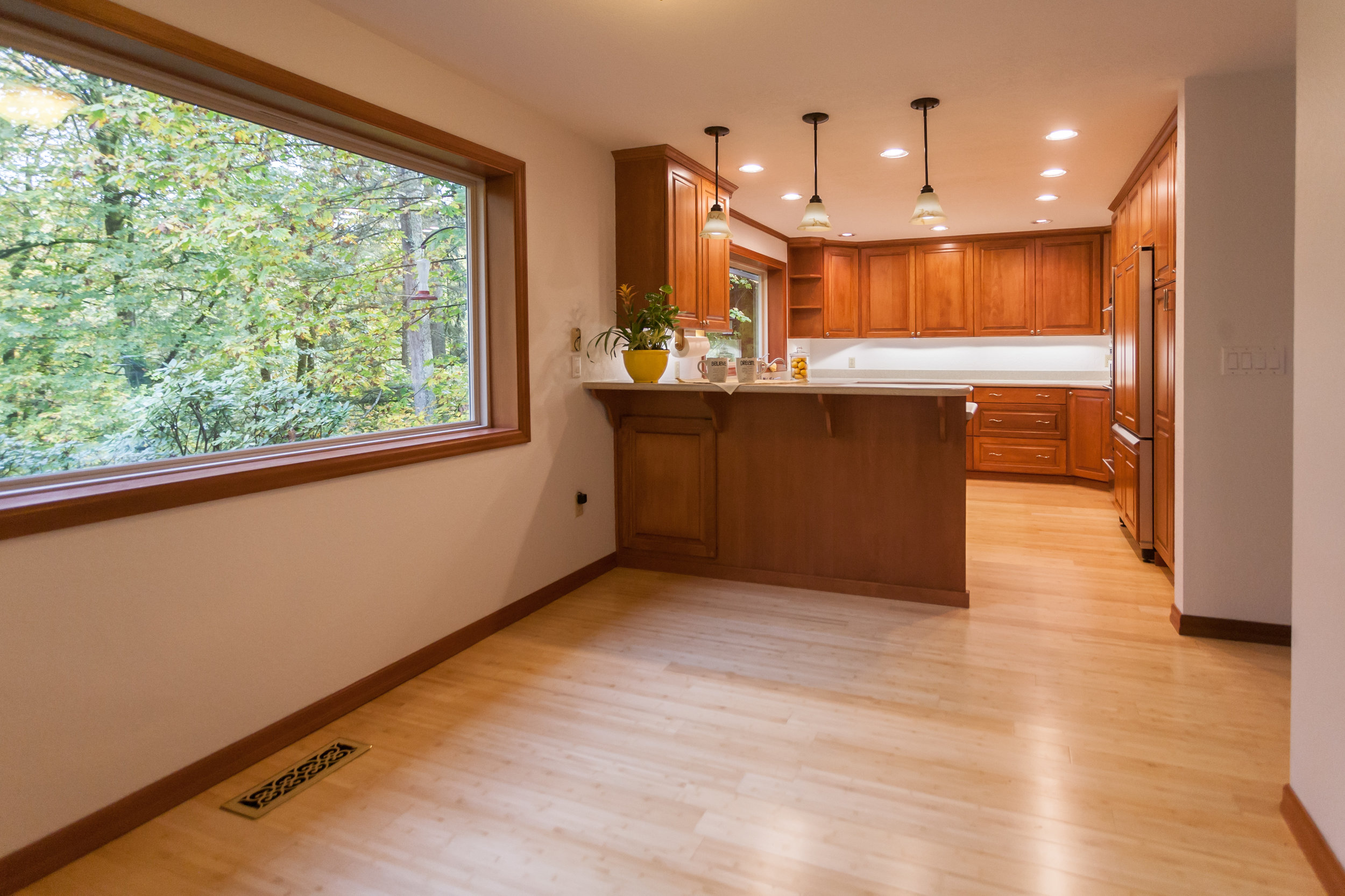  Kitchen has it all. Stainless appliances. Corian countertops. No Ikea cabinets here! Full wood and special-ordered. Look out at the trees and yard from every window in the house...especially at the kitchen sink! 