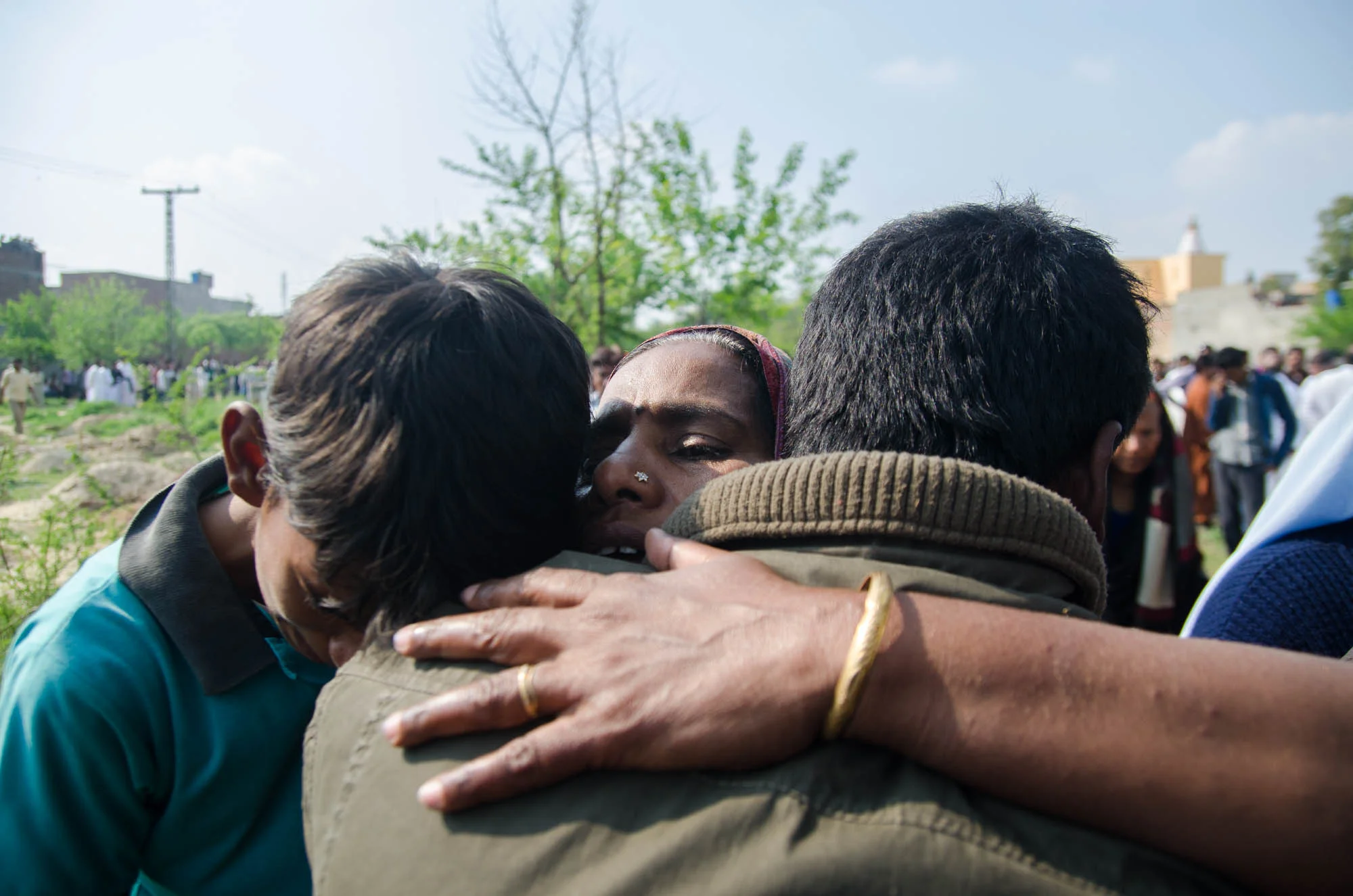 A mother comforts and is comforted by her sons during the funeral of her third son who died in a suicide attack on two churches in Lahore’s Youhanabad area.