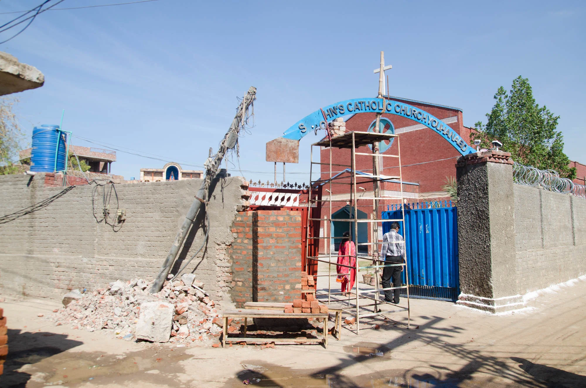 The wall of St. John’s Catholic Church being reconstructed after a suicide attack killed 15 including 2 police officers