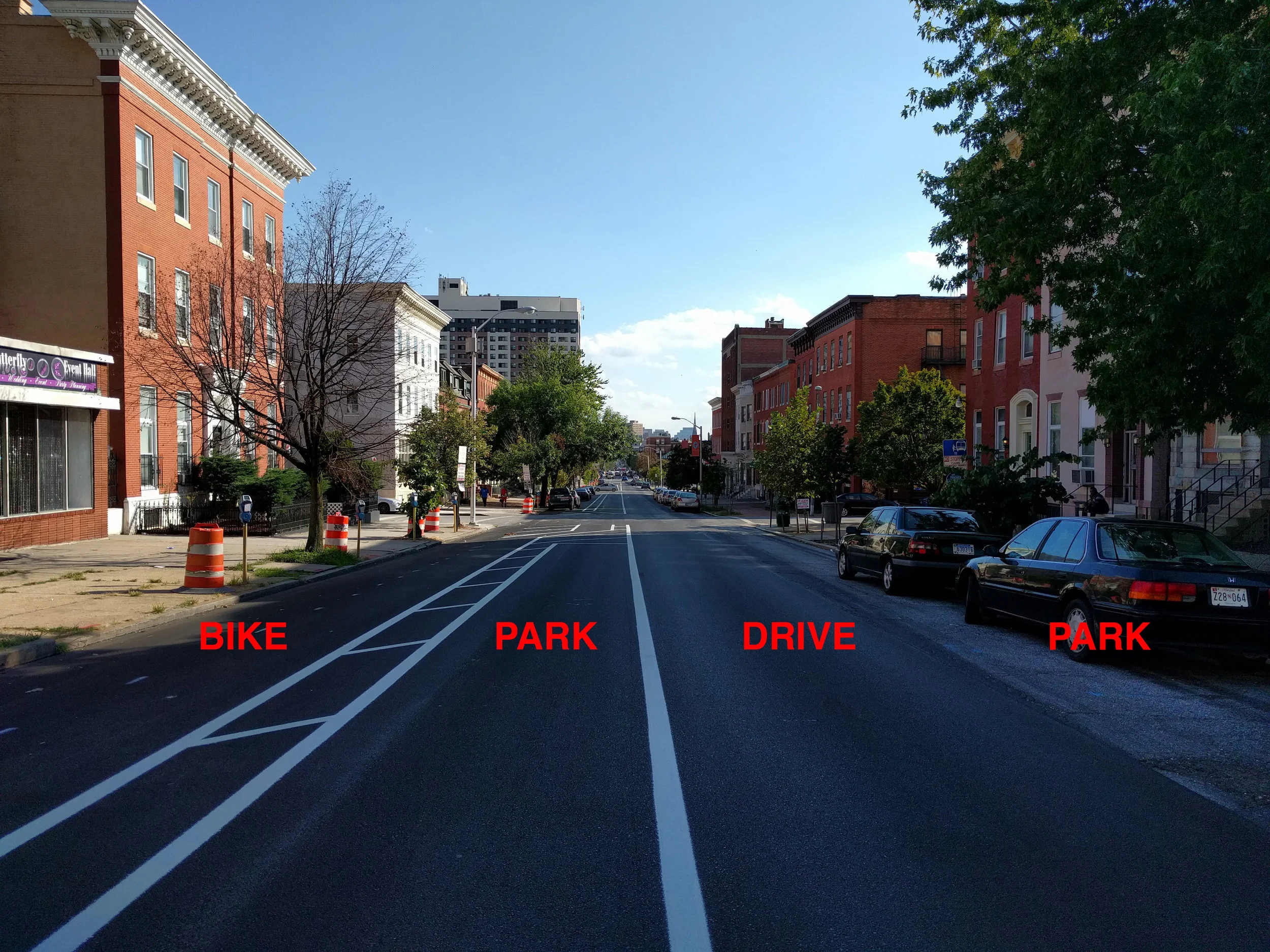Left to right: two-way bike lane, parking lane, car driving lane, parking lane.
