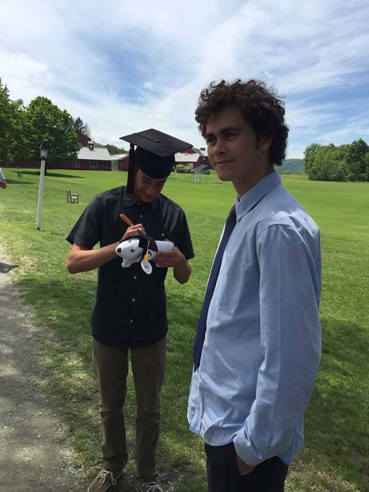 My son (in blue) smiling on graduation day with his friend .