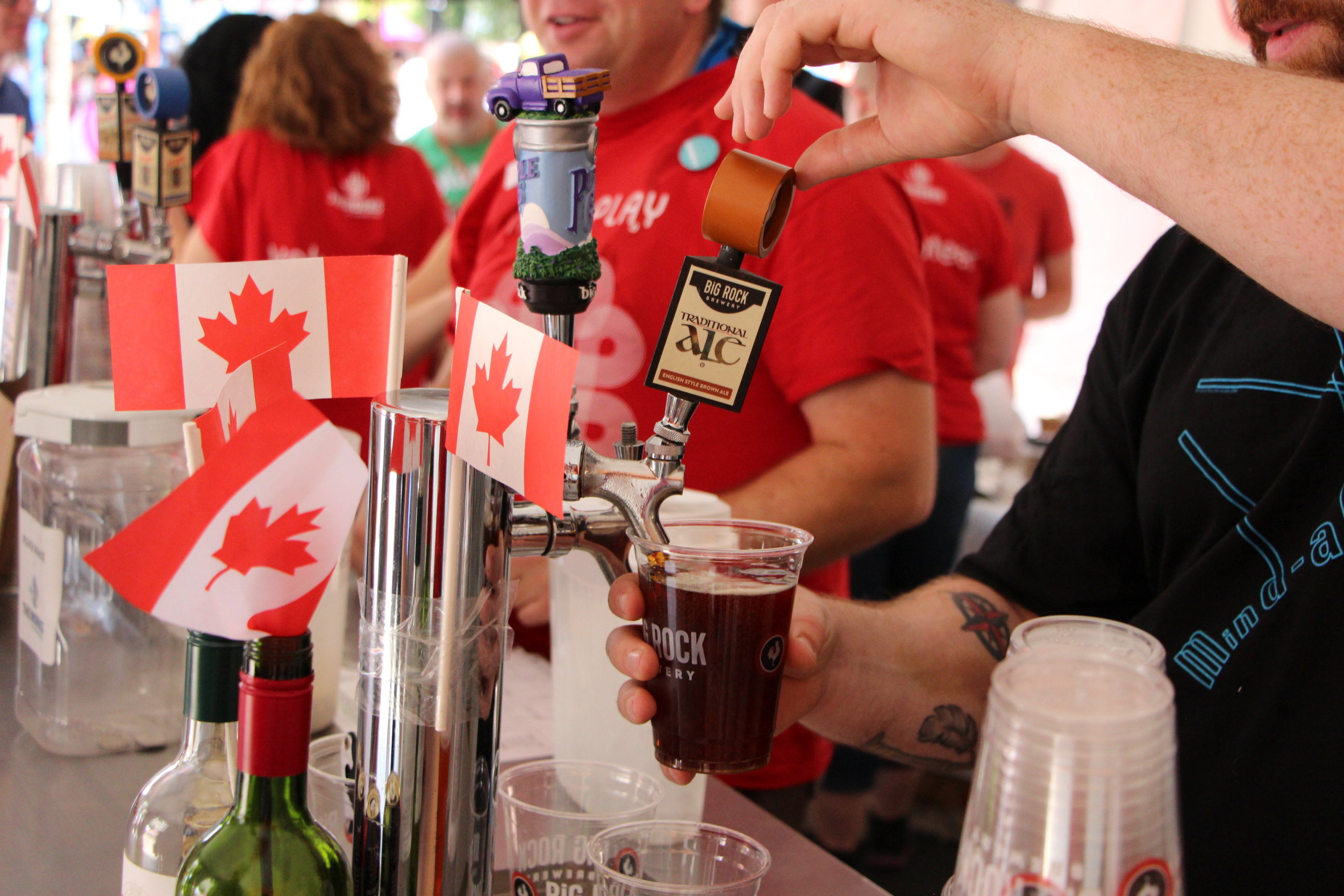  A volunteer serves beer at The Works Patio on Canada Day, 2017. 