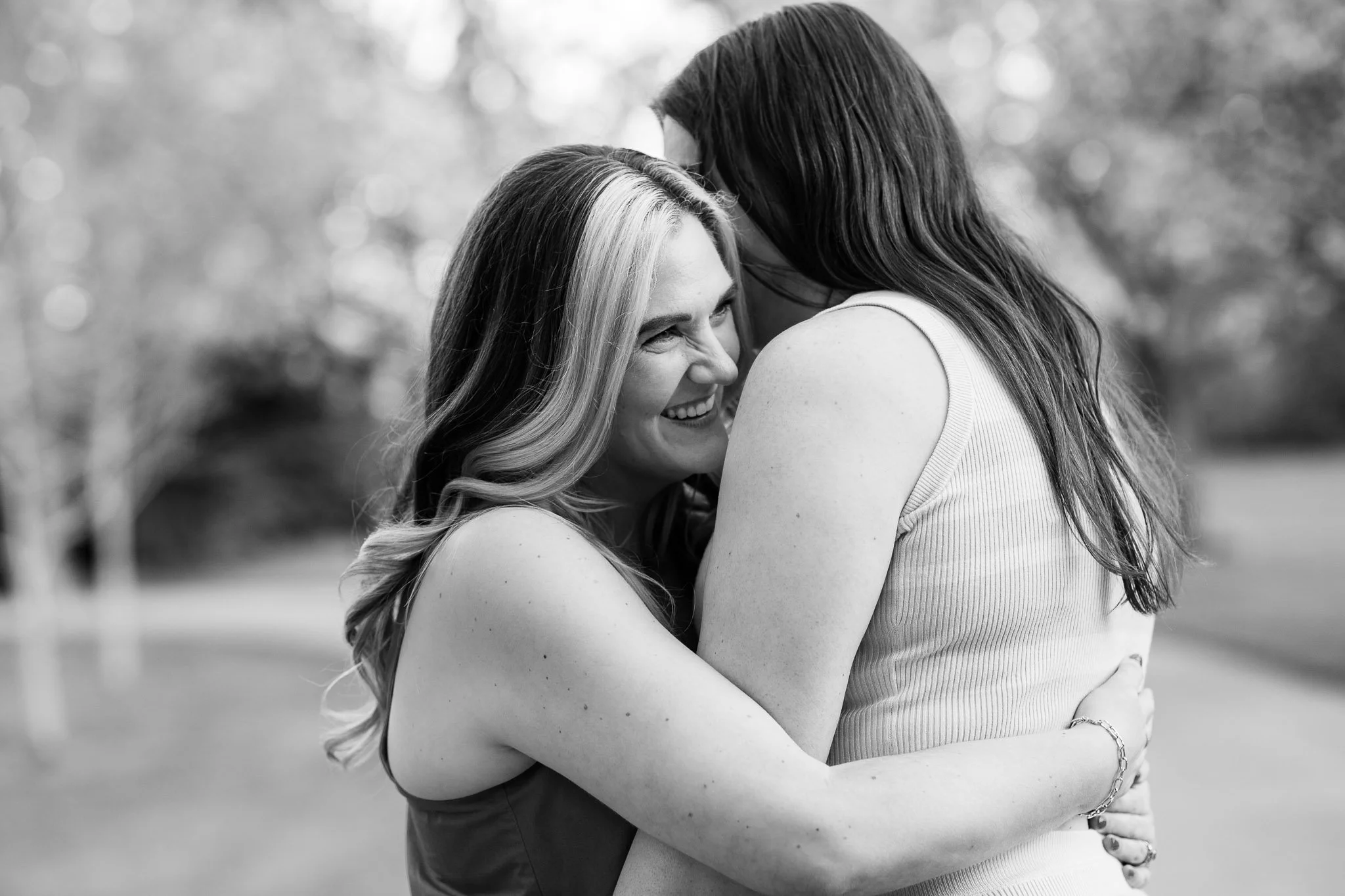 Candid moment of laughter between Dianna and Annika during their relaxed spring engagement session.