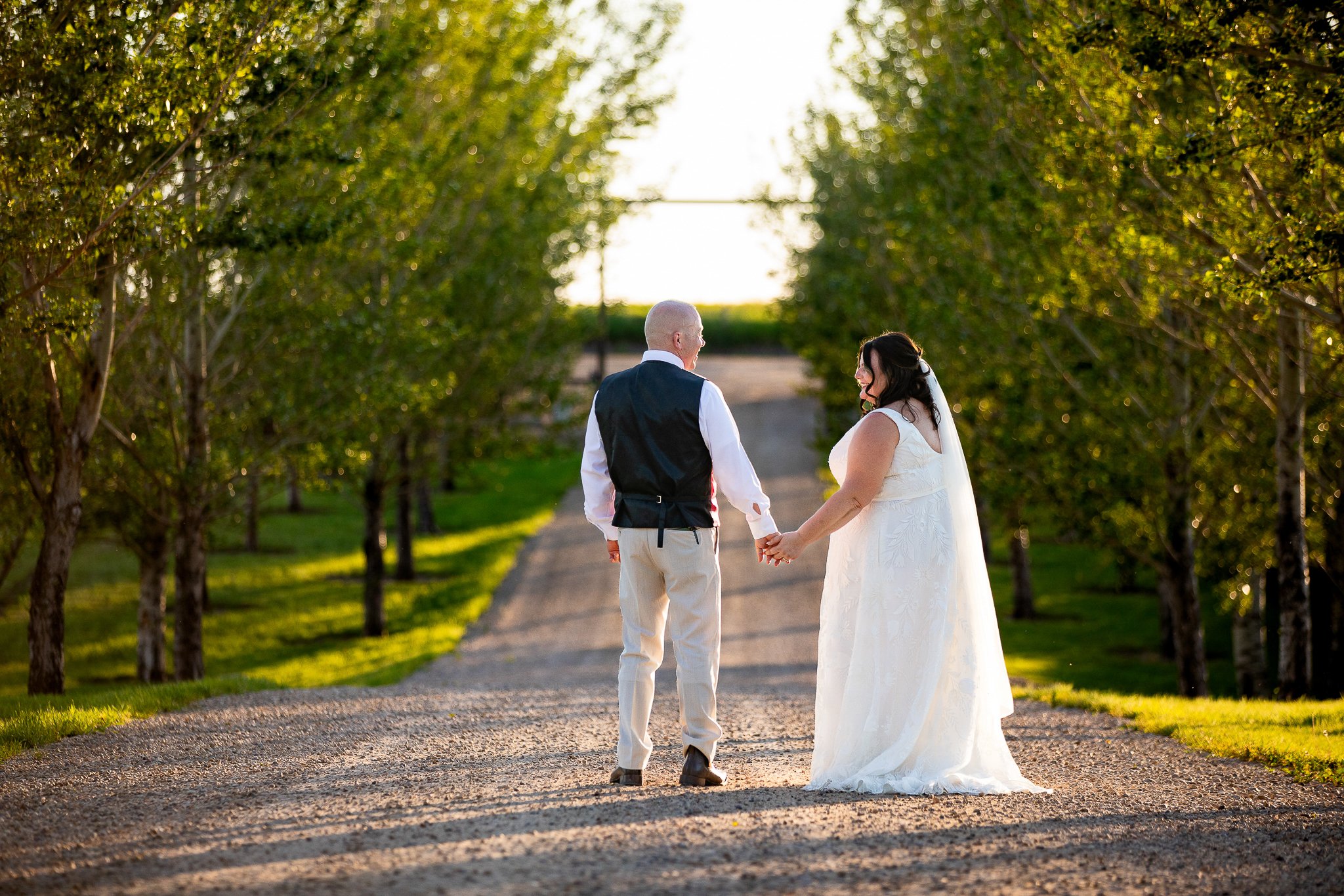 Bride and groom at sunset in the Alberta countryside near Prairie Lane Barn