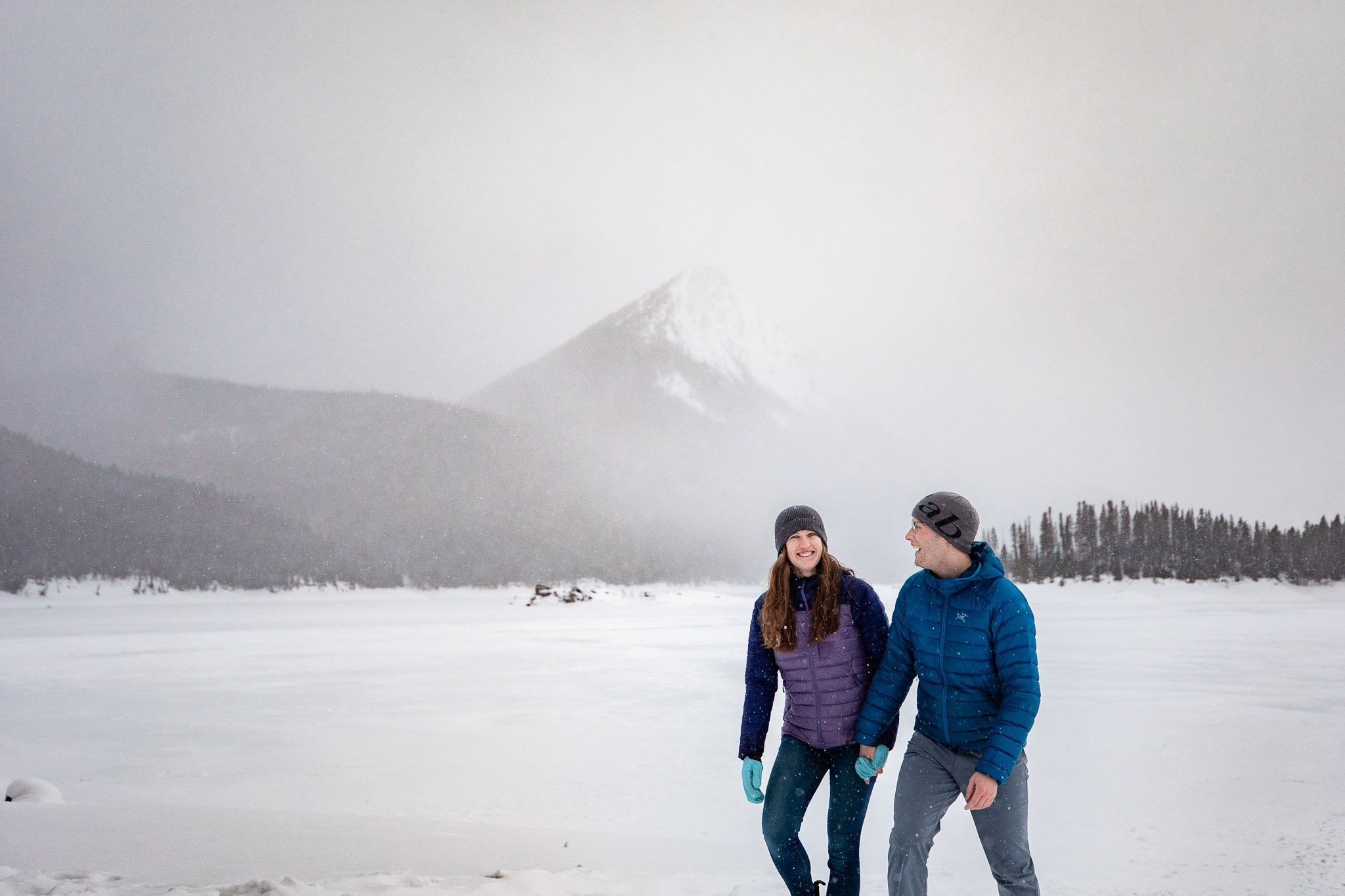 Tyler and Taryn share a quiet moment as mountain views emerge through the fog in Kananaskis.