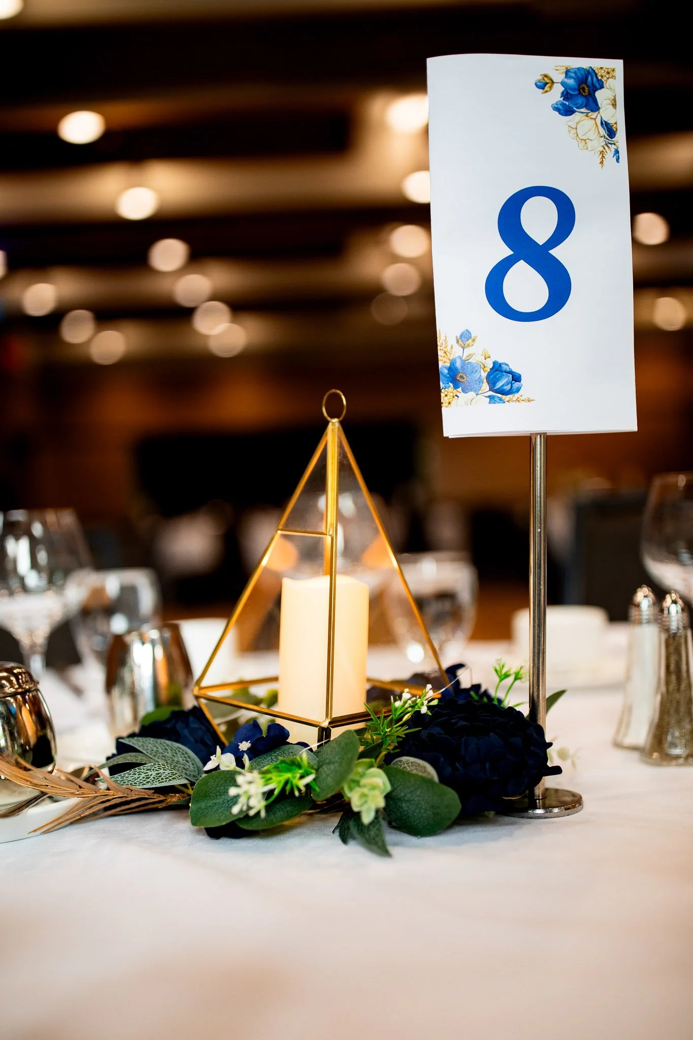 Reception tables beautifully decorated inside the ENMAX Conservatory for a Calgary Zoo wedding.
