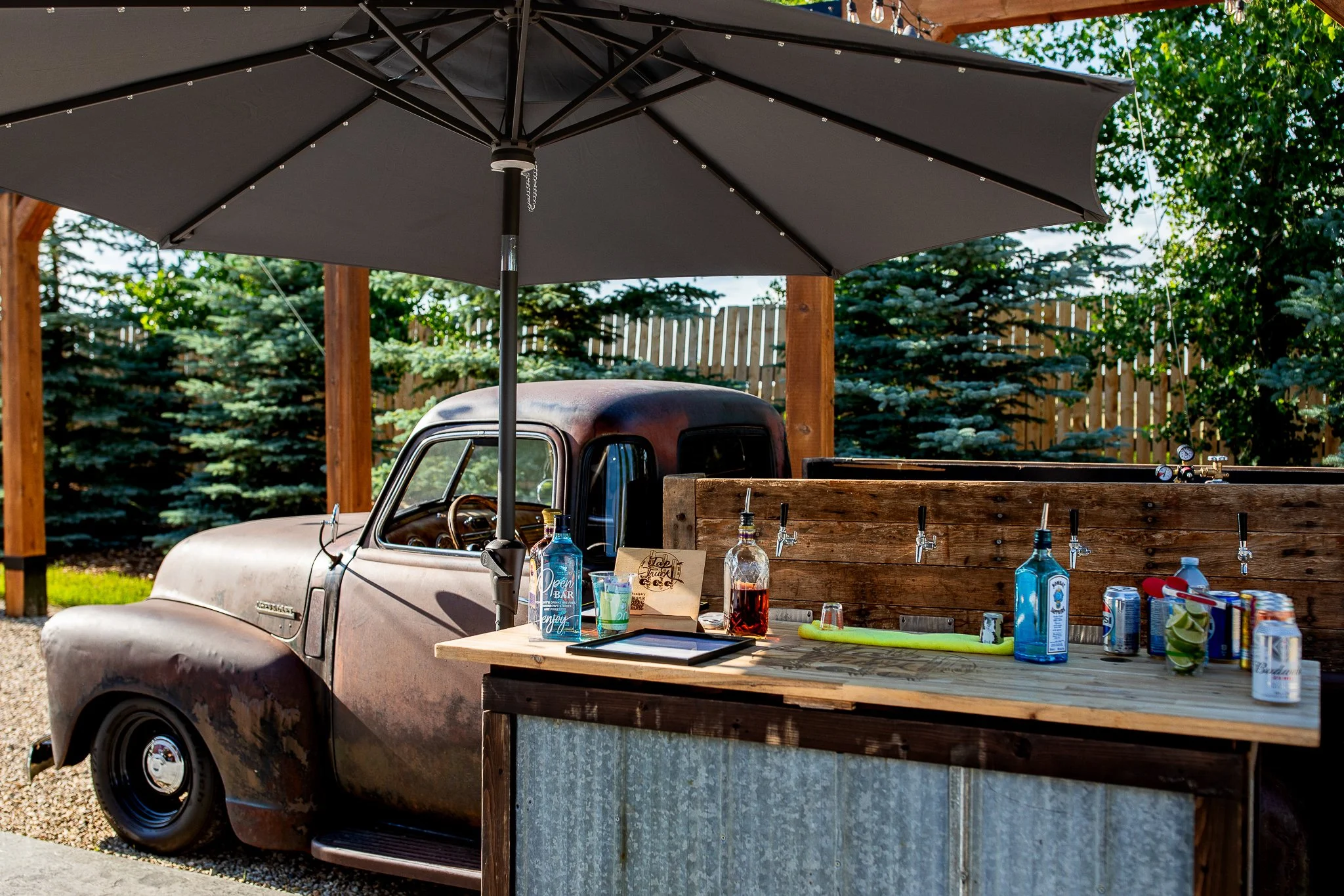 Restored 1949 Chevy tap truck serving drinks to guests at a Calgary barn wedding