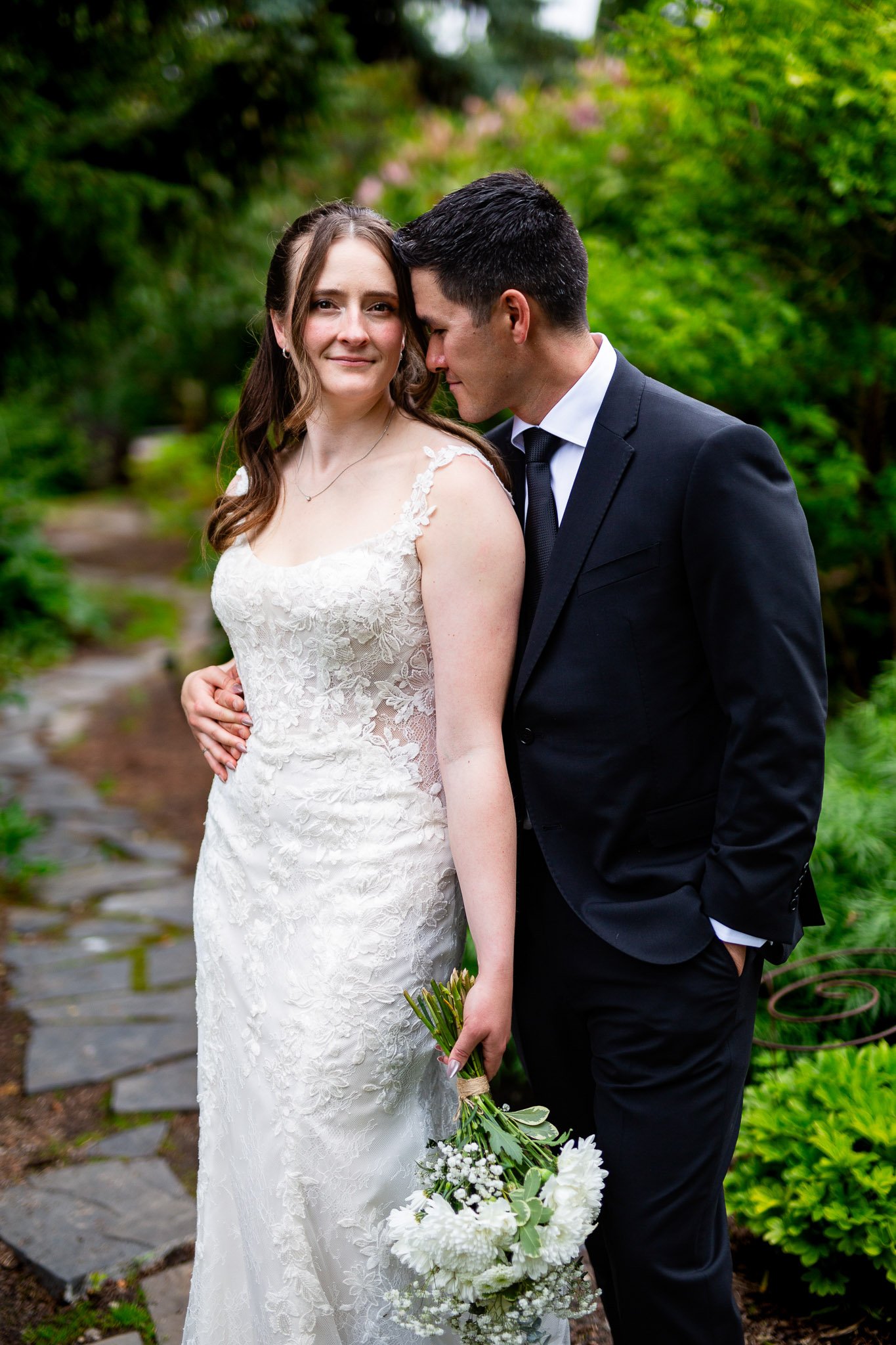 The bride smiling during portraits in the vibrant Calgary Zoo gardens.