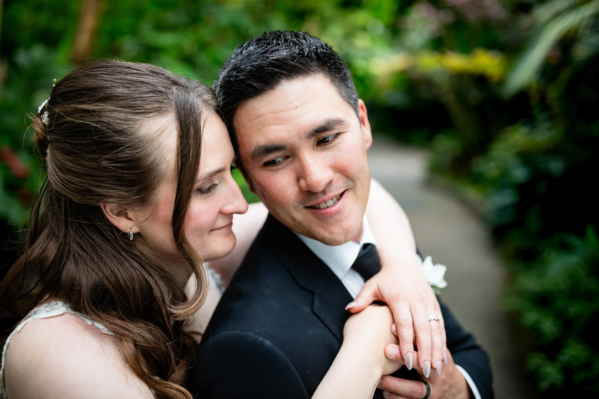 Evening wedding portraits outside the ENMAX Conservatory with romantic lighting.