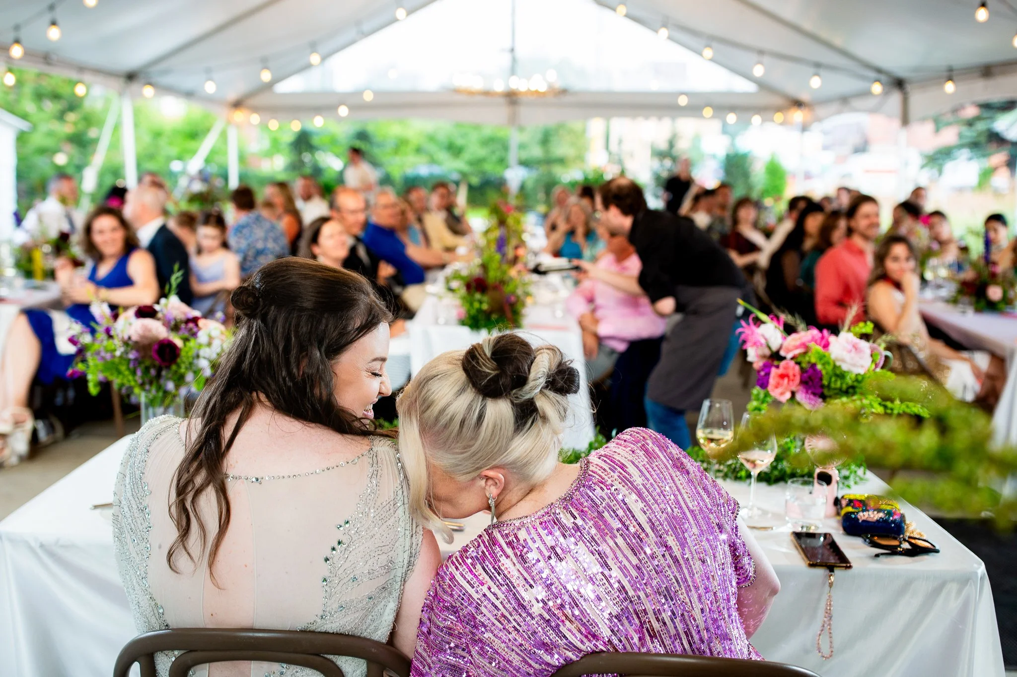 The newlyweds share a joyful moment with friends and family during their Calgary outdoor tent celebration.
