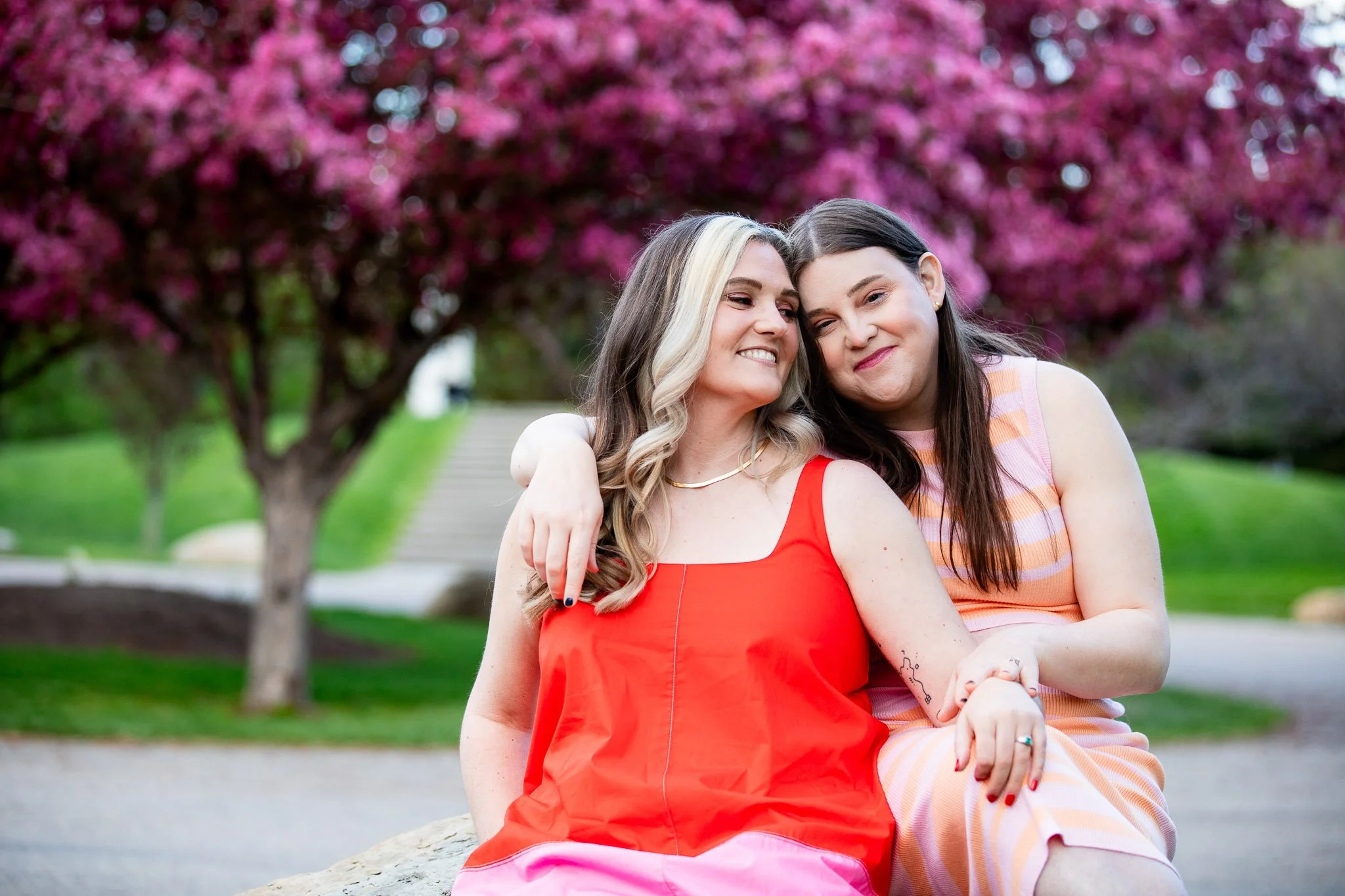Romantic portrait of couple among blooming trees at Baker Park in Calgary.
