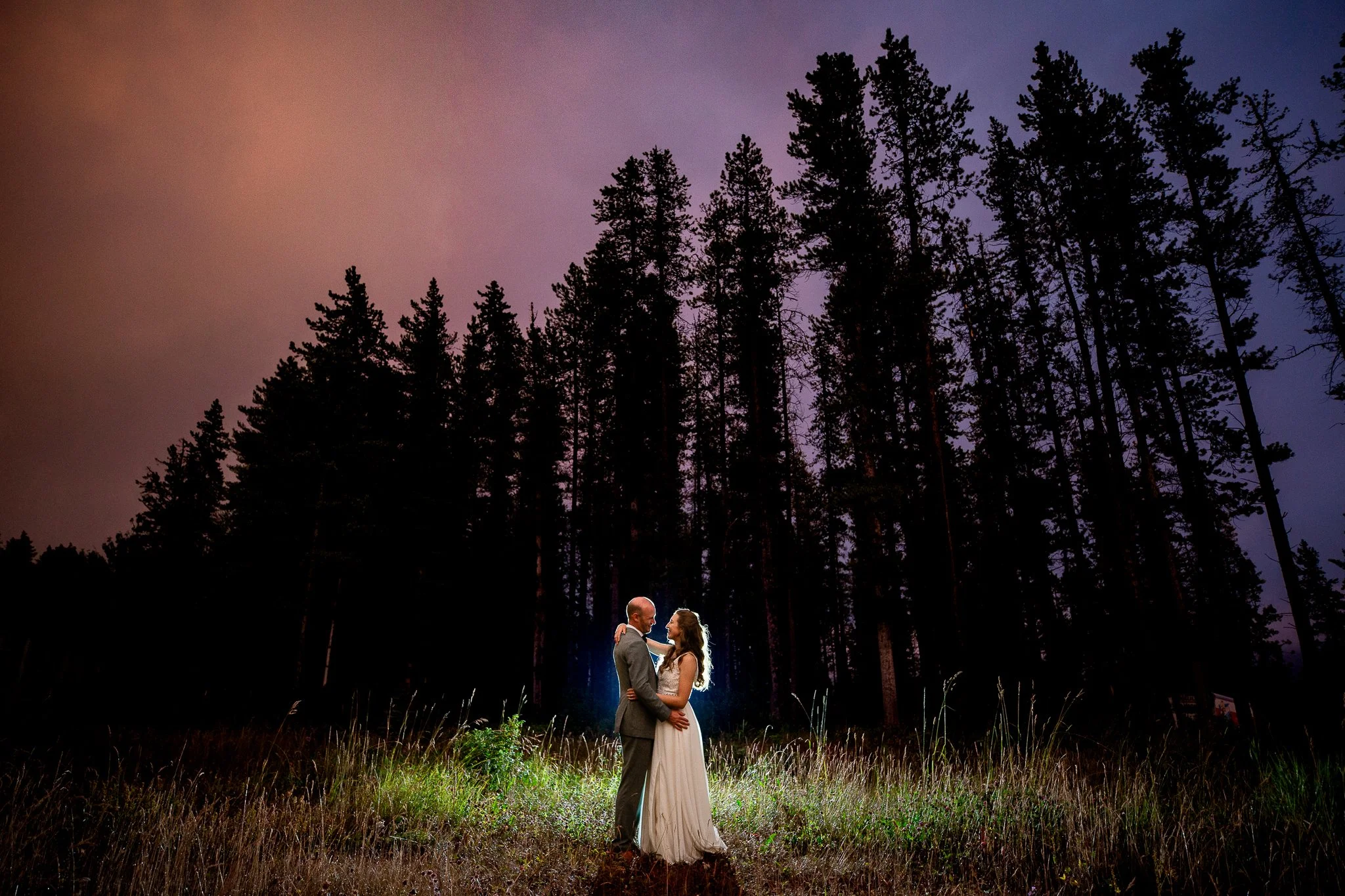 Bride and groom at sunset with prairie foothill views at their Trappers Hill Lodge wedding