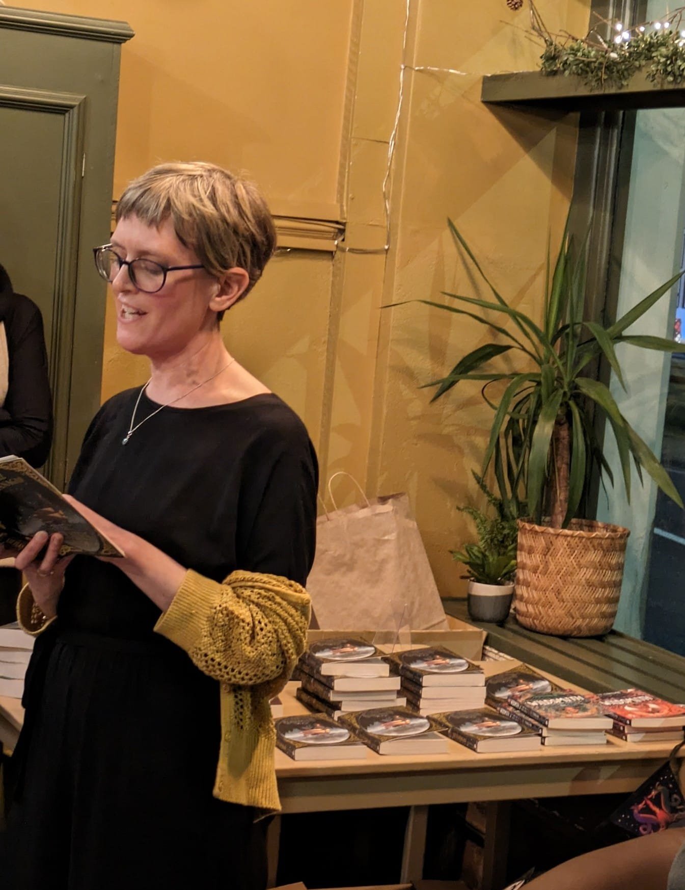 Liz reading at launch w books.JPG