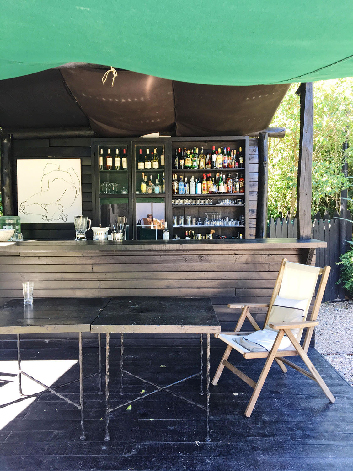 At Garzon: (above) the very chic tented bar in the garden; (below) the dining room; outdoor tables.