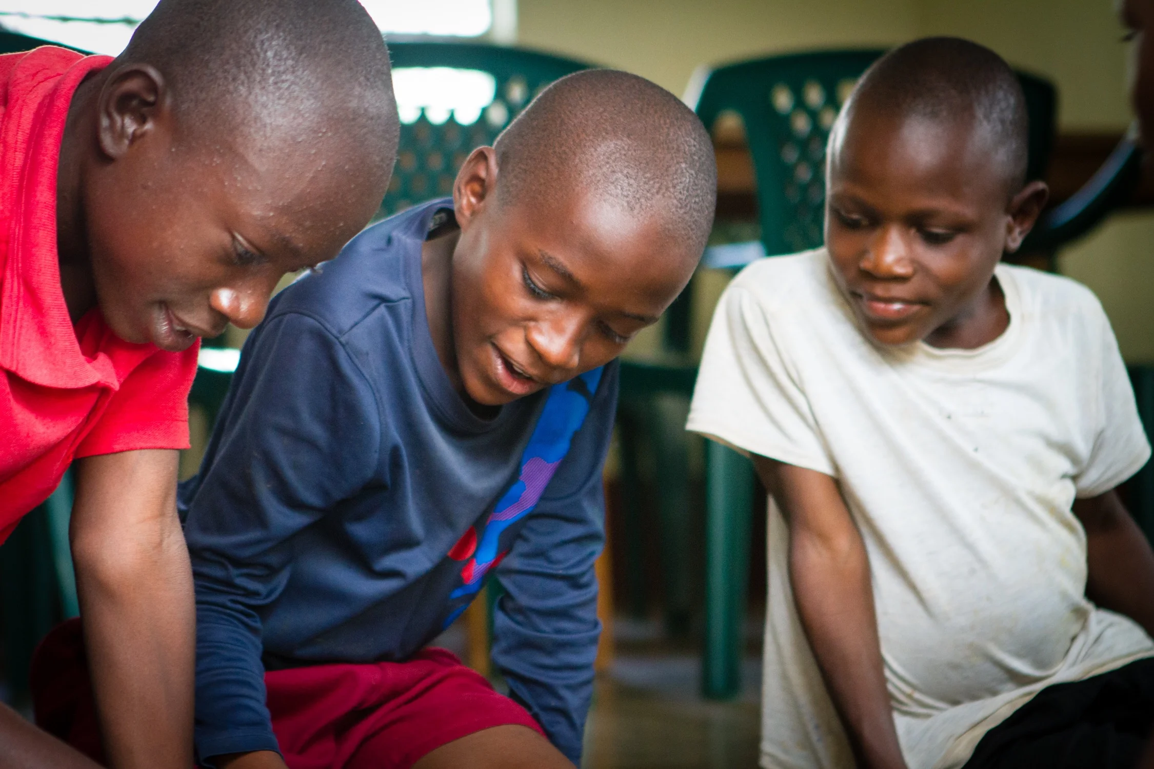 Evans (middle) shows John (right) and Austin (left) how to put together a difficult puzzle.