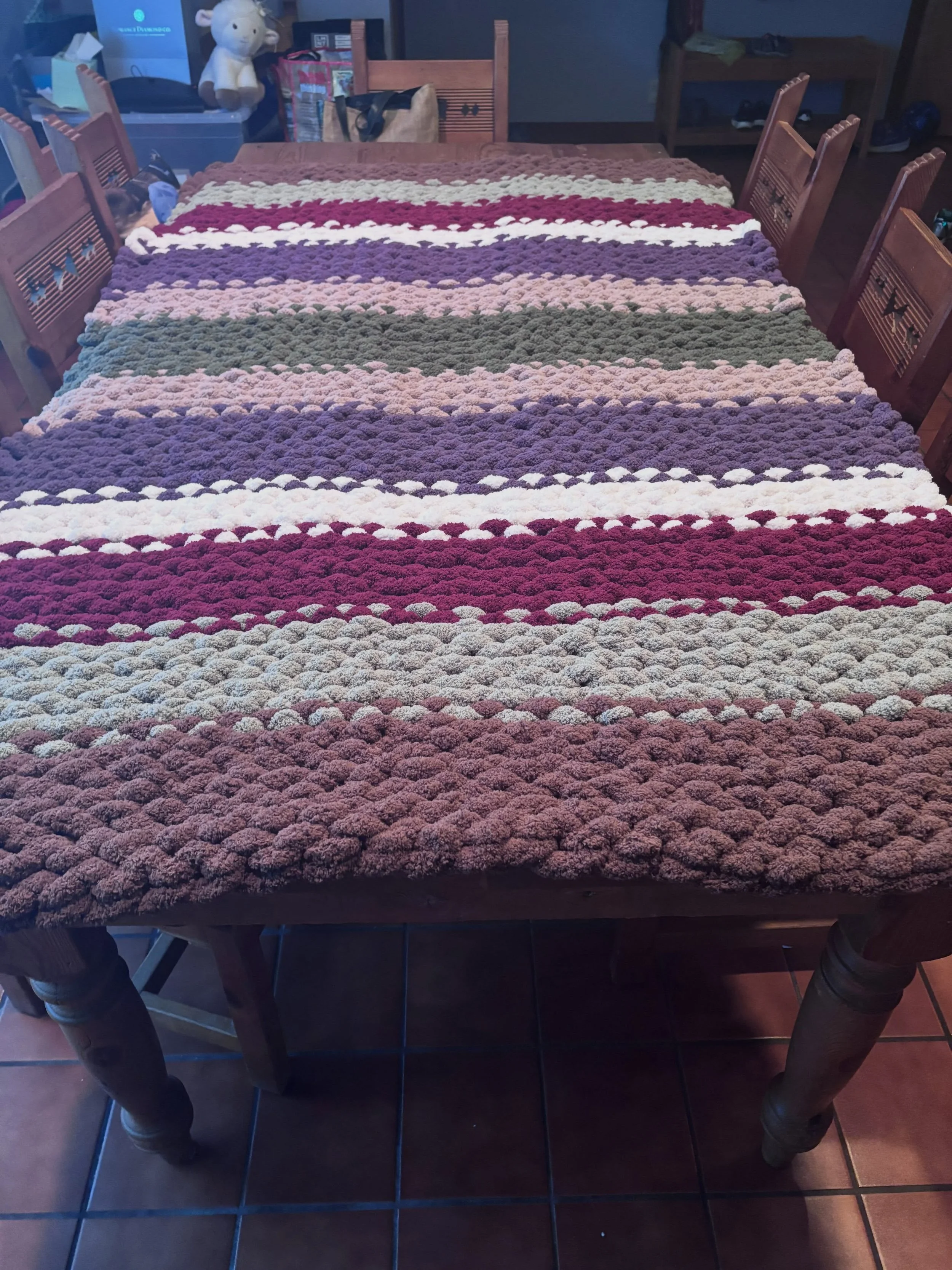 Do you know would be just perfect for this upcoming temperature drop? One of these hand knit blanket made by local artisan Tarri Fennel. 

She gave me one for Christmas last year and it instantly became my very favorite blanket in our house. They are