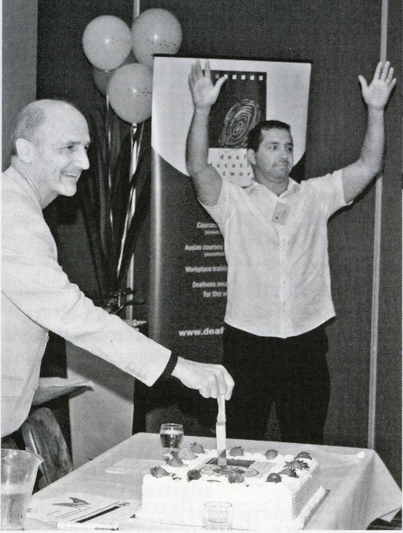 Michael Clancy cut DEN merger celebration cake 2008.jpg