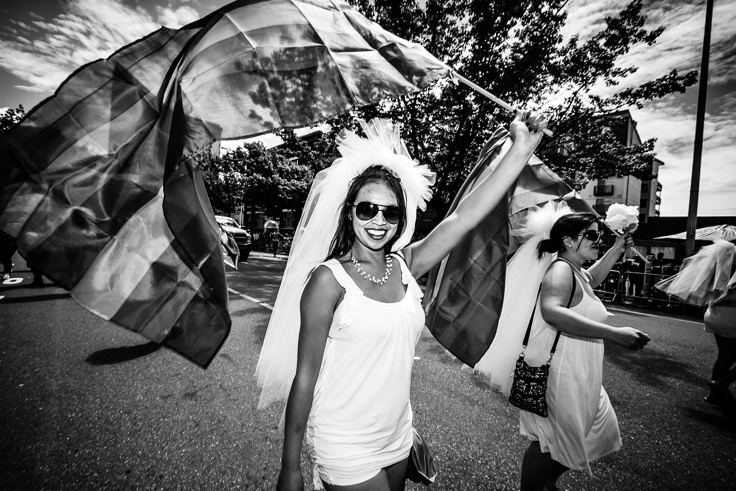 A woman dressed as a bride waves the Pride flag during the Seattle Pride Parade on June 24th, 2012.