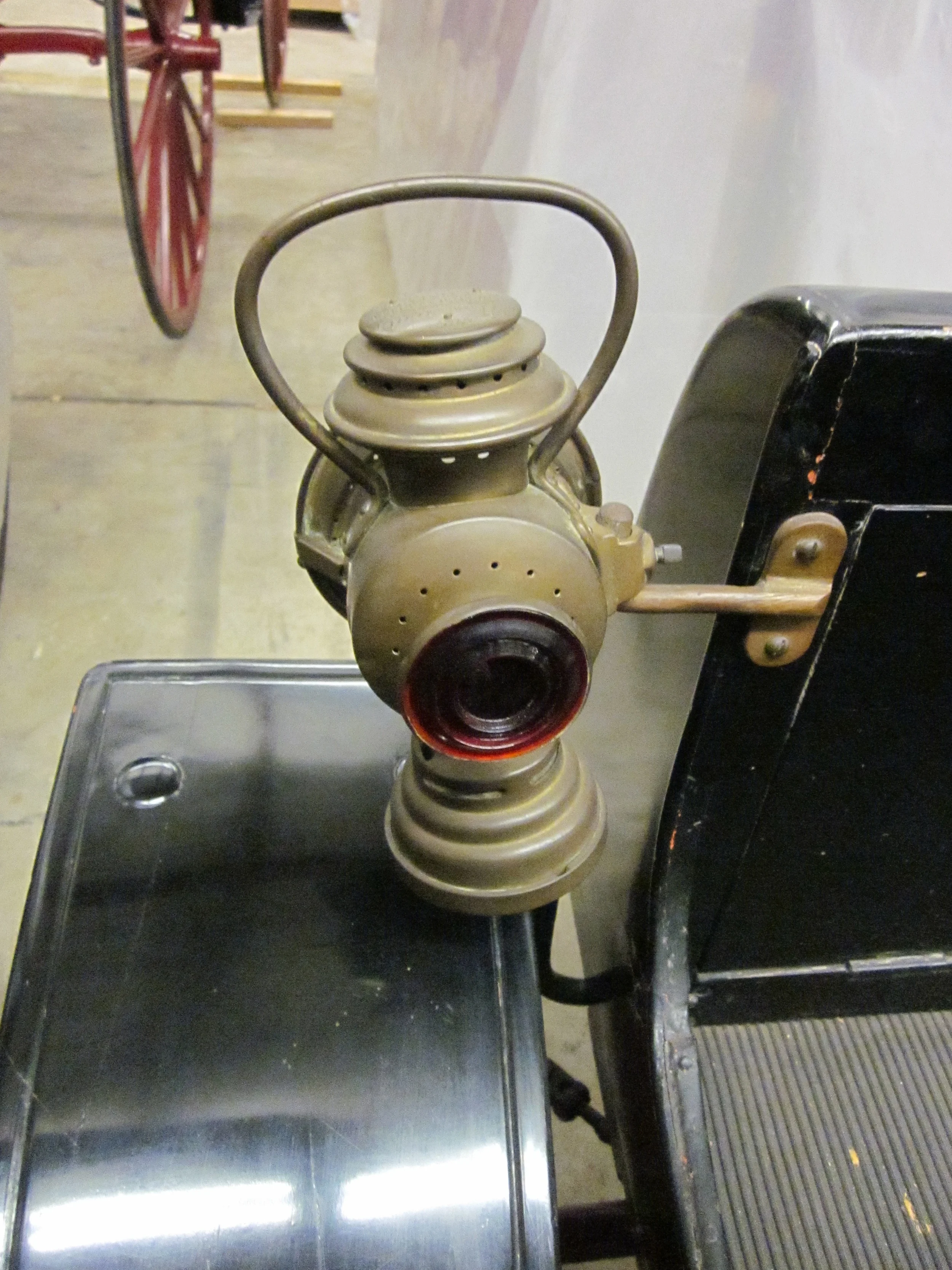Notice the red glass on the back of the lamp. It acted as an early "taillight," though it was side-mounted in the front, and it would have glowed red when the lamp was lit. Photo by author. 