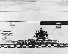 Stapp flies through the desert on one of the Sonic Wind Rocket Sleds.