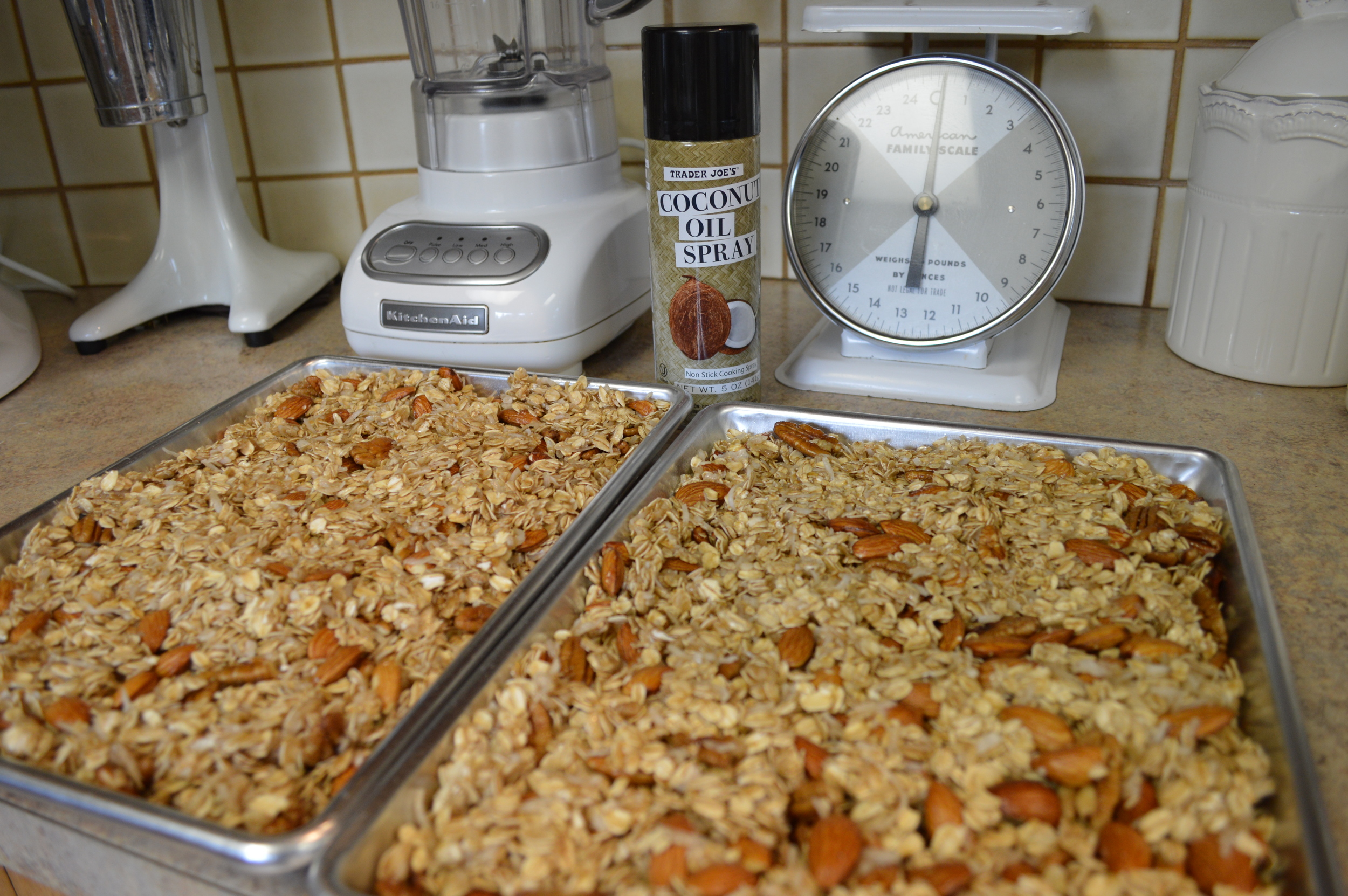 Granola mixture spread in pans to bake...coated with Trader Joe's Coconut Oil spray.