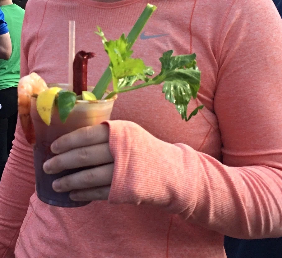 Bloody Mary with garnish of celery, shrimp, lemon, and a beef stick!