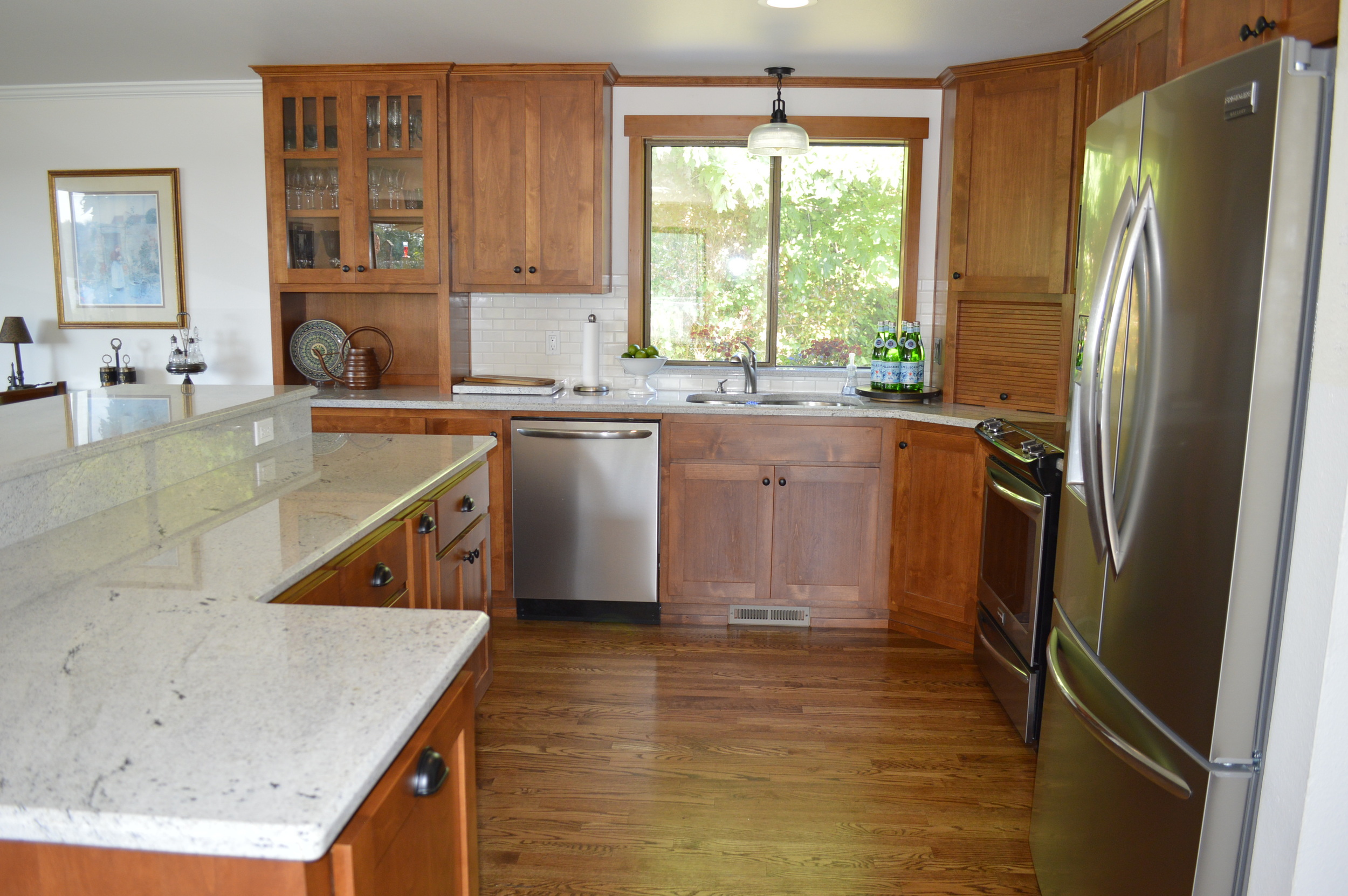 Lovely shaker style Alder cabinets and Nordic White granite...