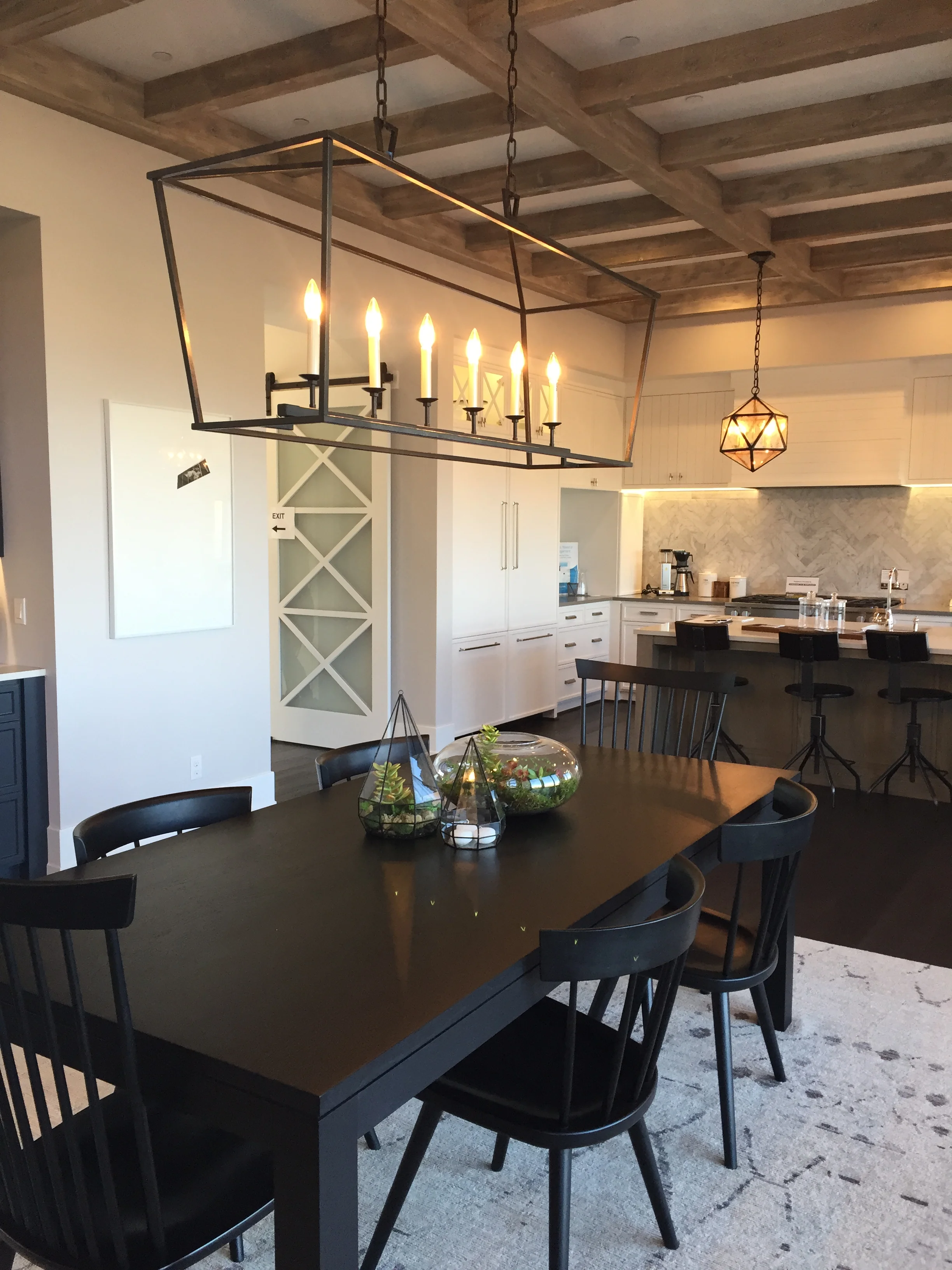 Loved the elongated lantern style fixture as well as the pendant light...and the rough beams on ceiling.