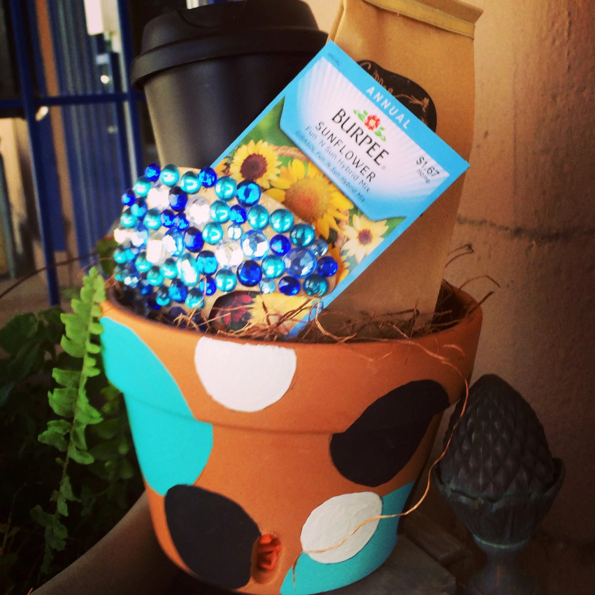 A garden style gift! Hand painted pot with coffee, travel mug and seeds to grow in pot. 