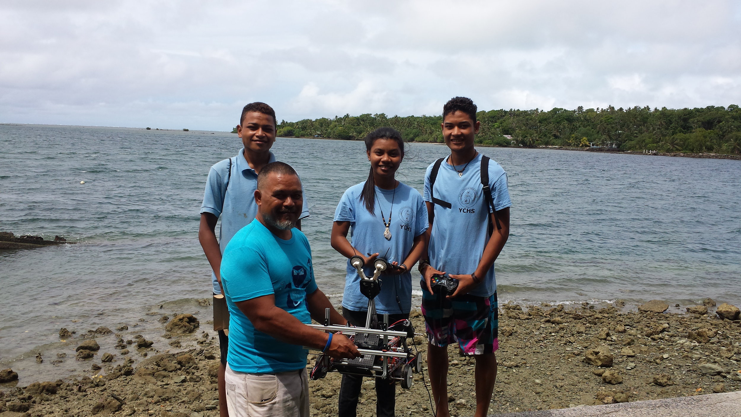 Natasha Loochaz, John Steven Gilinug, and Francis Yarofalyango of Micronesia's Robotics Team with Mr. Larry Raigetal.