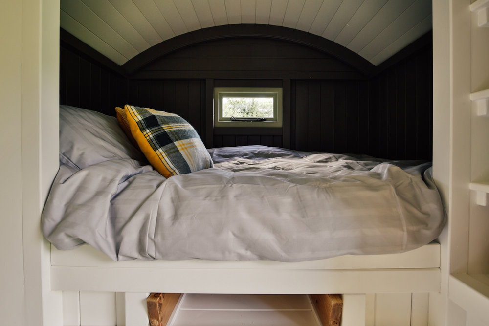  Interior photography of shepherds hut guest room cabin bed 